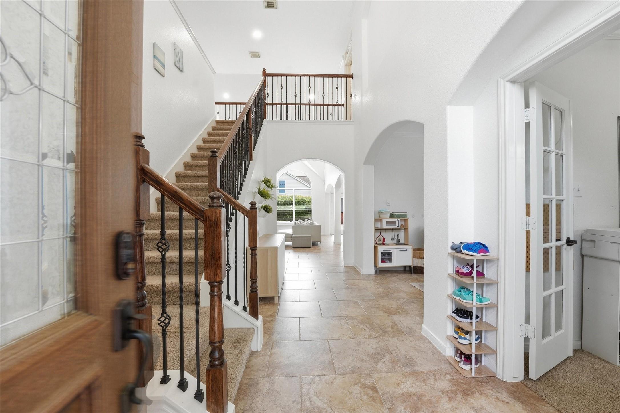 Image 4: This is a two-story brick home with a two-car gara