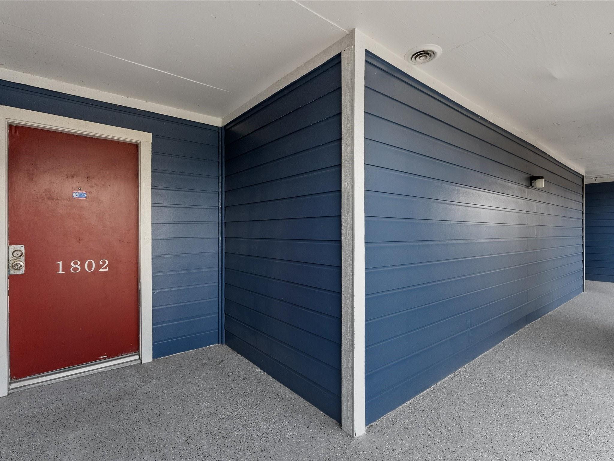 Image 4: Front door entrance.  Solid doors and the paint is