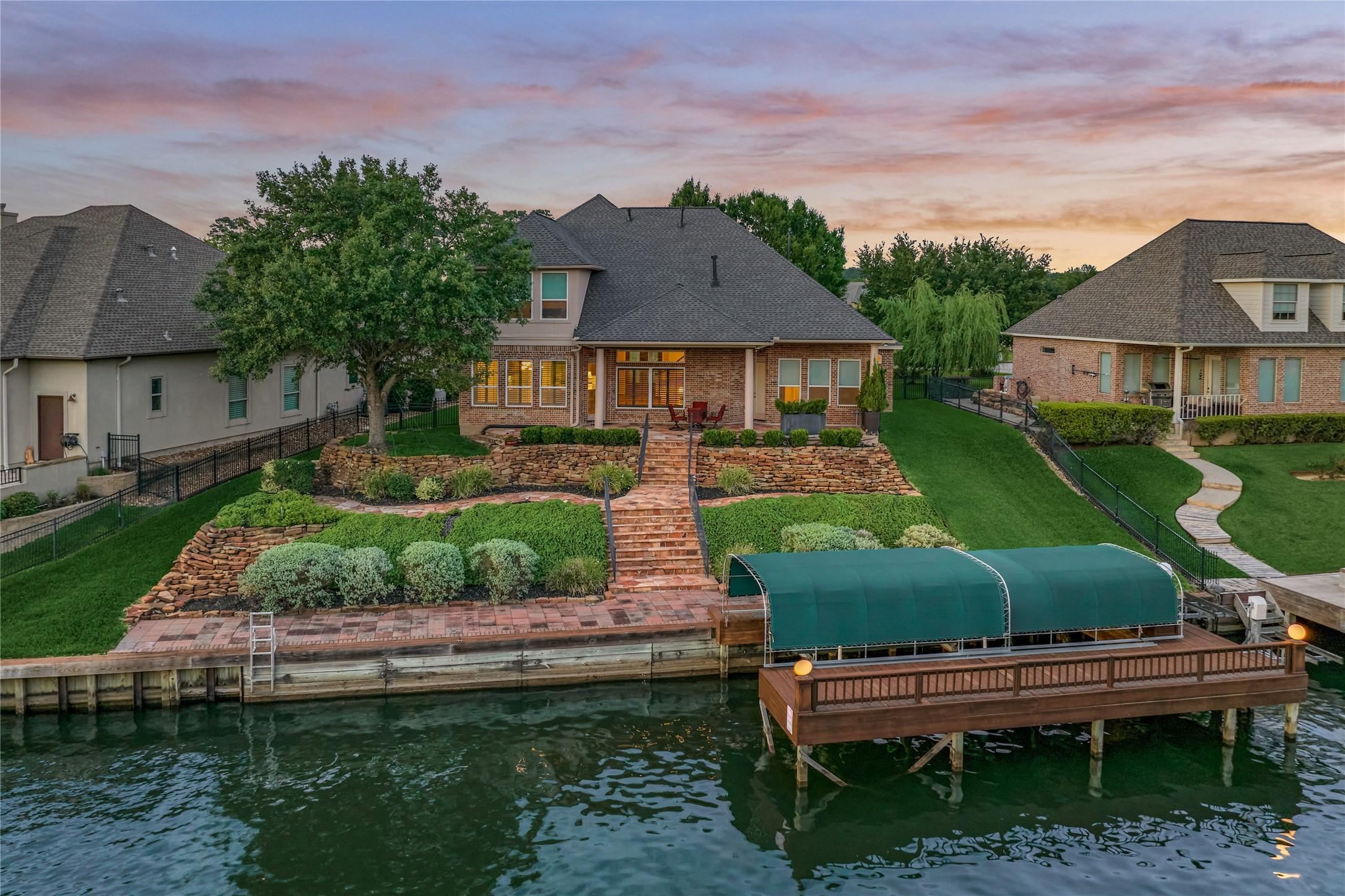 Image 1: Beautiful custom waterfront home nestled within th