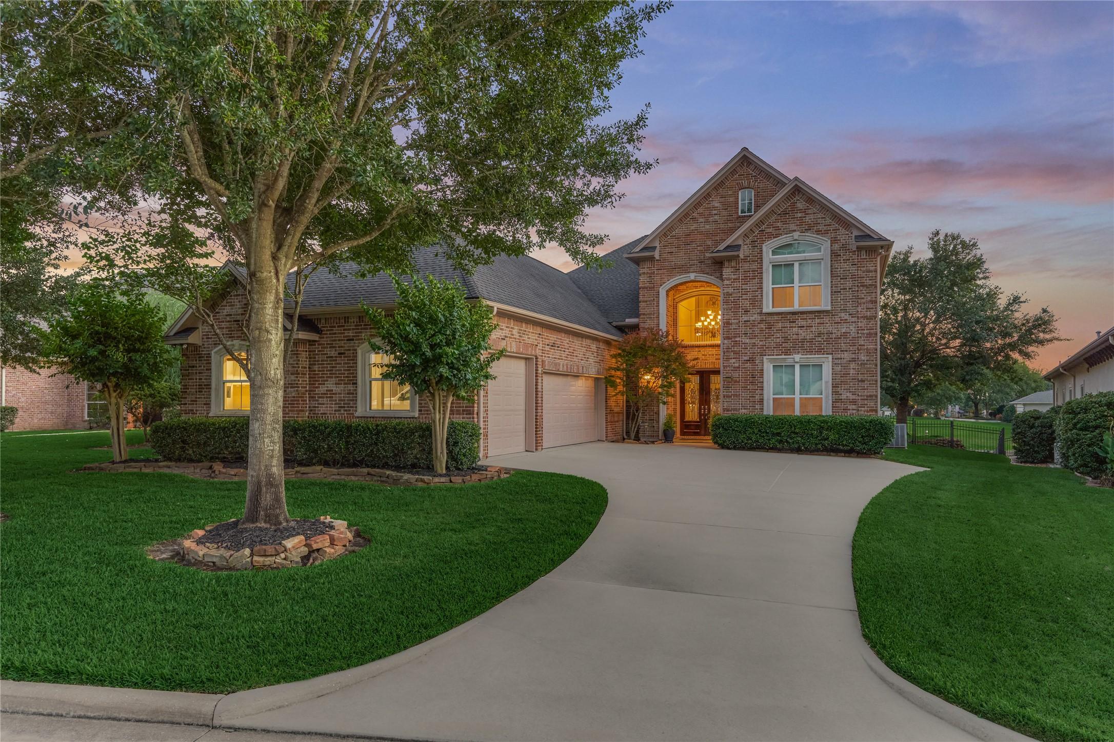 Image 2: This lovely custom home showcases an all-brick ext