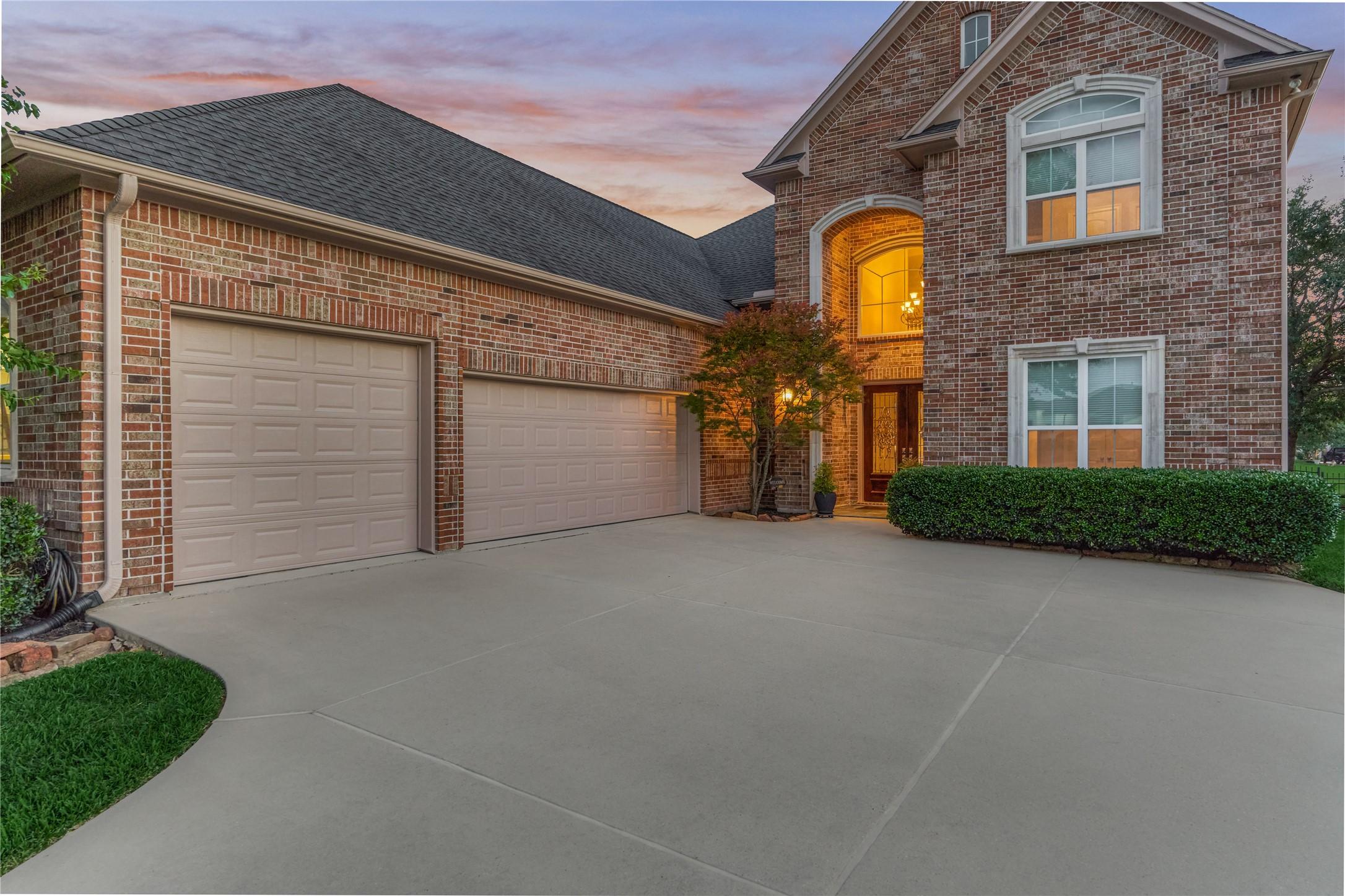 Image 4: Oversized 3-car garage featuring an extra-long bay