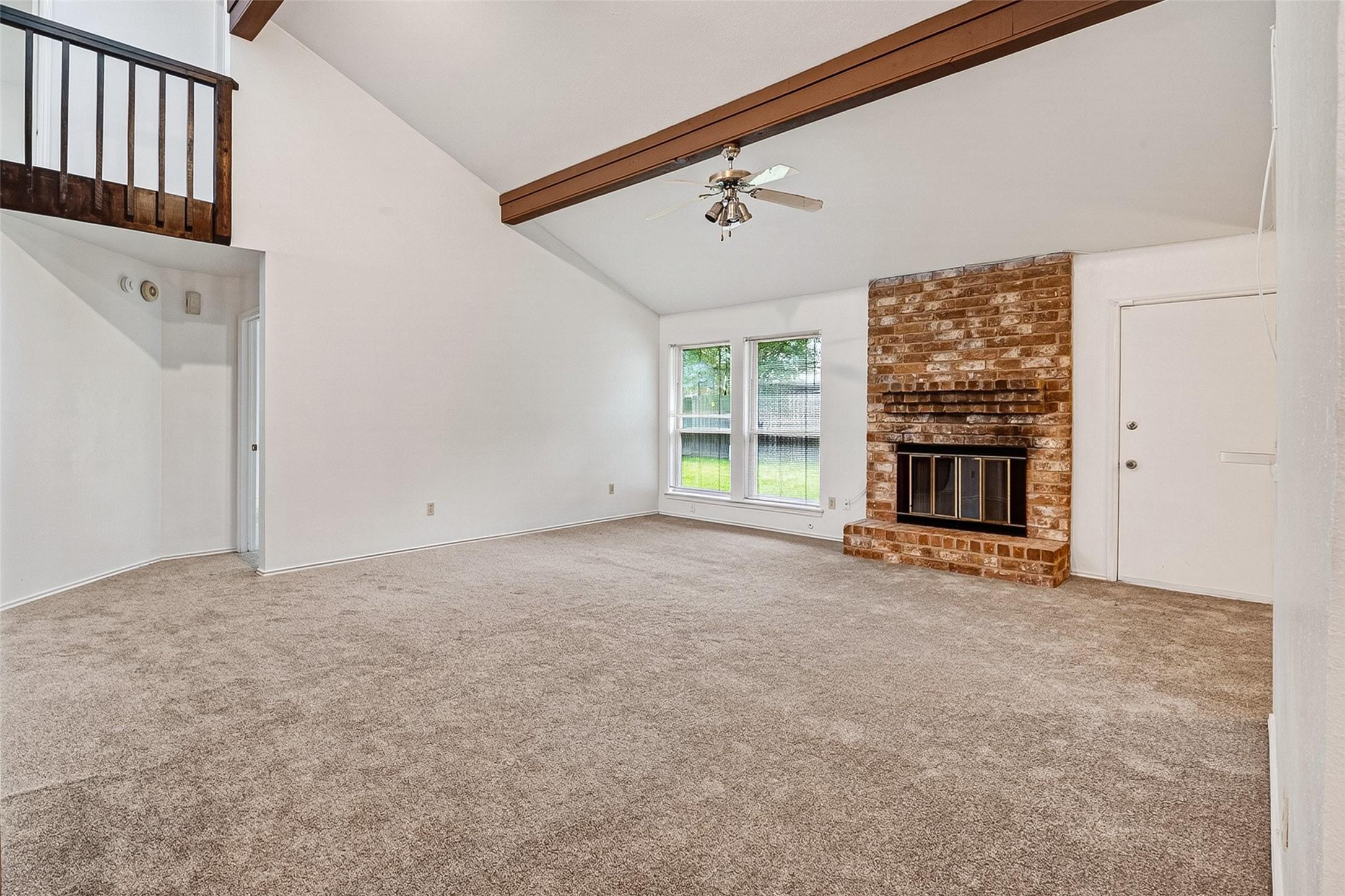 Image 4: Living room view showing vaulted ceiling with wood