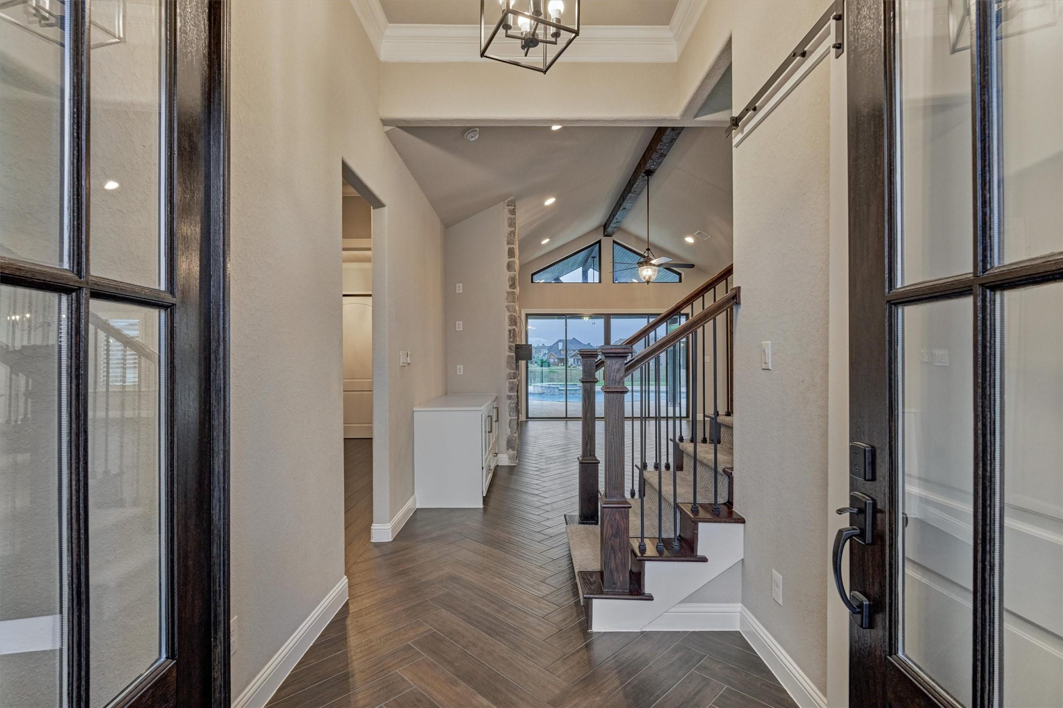 Image 4: Glass-paneled front doors open to a bright, welcom