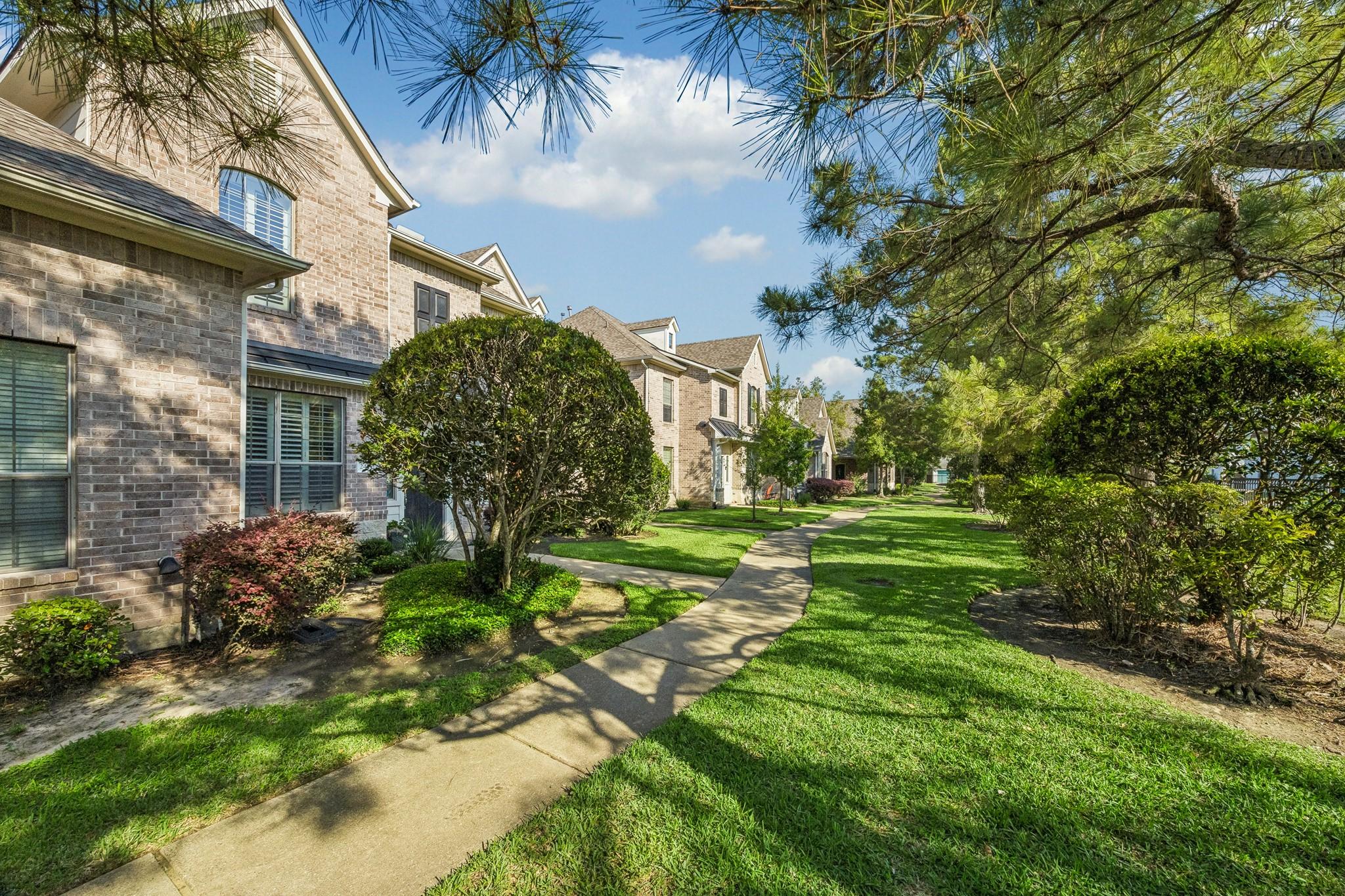 Image 2: Enjoy well manicured green space in front of the t