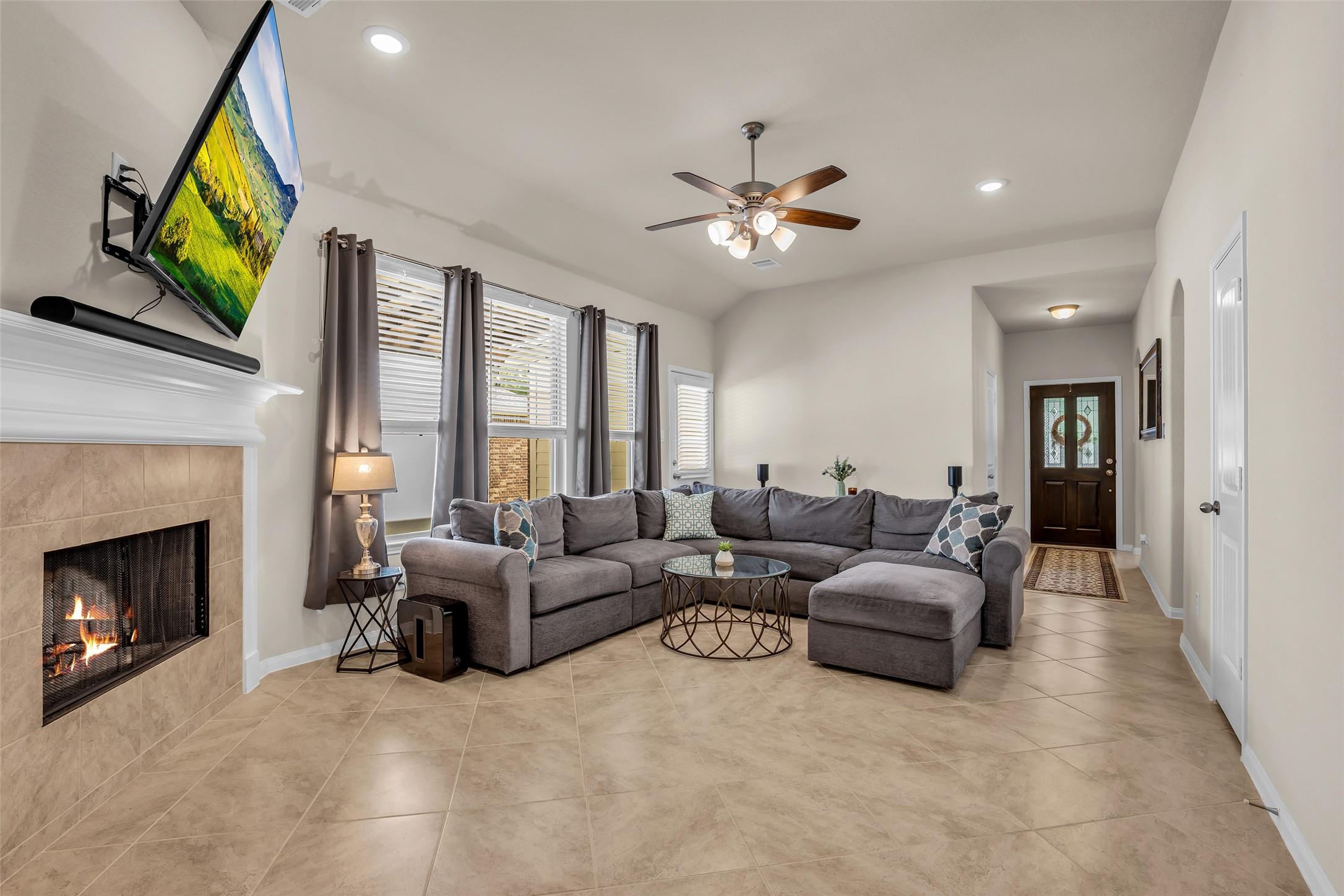 Image 3: This inviting living room features a cozy fireplac