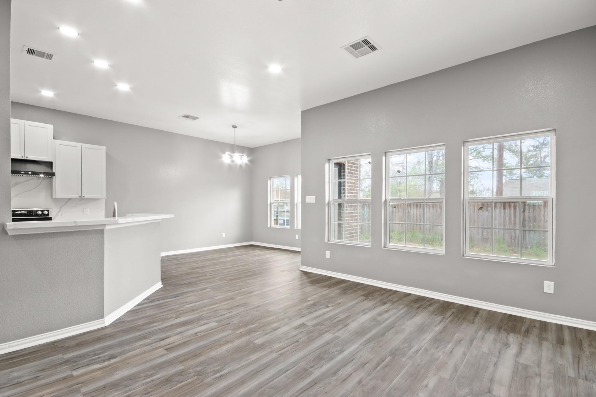 Image 3: This bright and open living space features sleek w