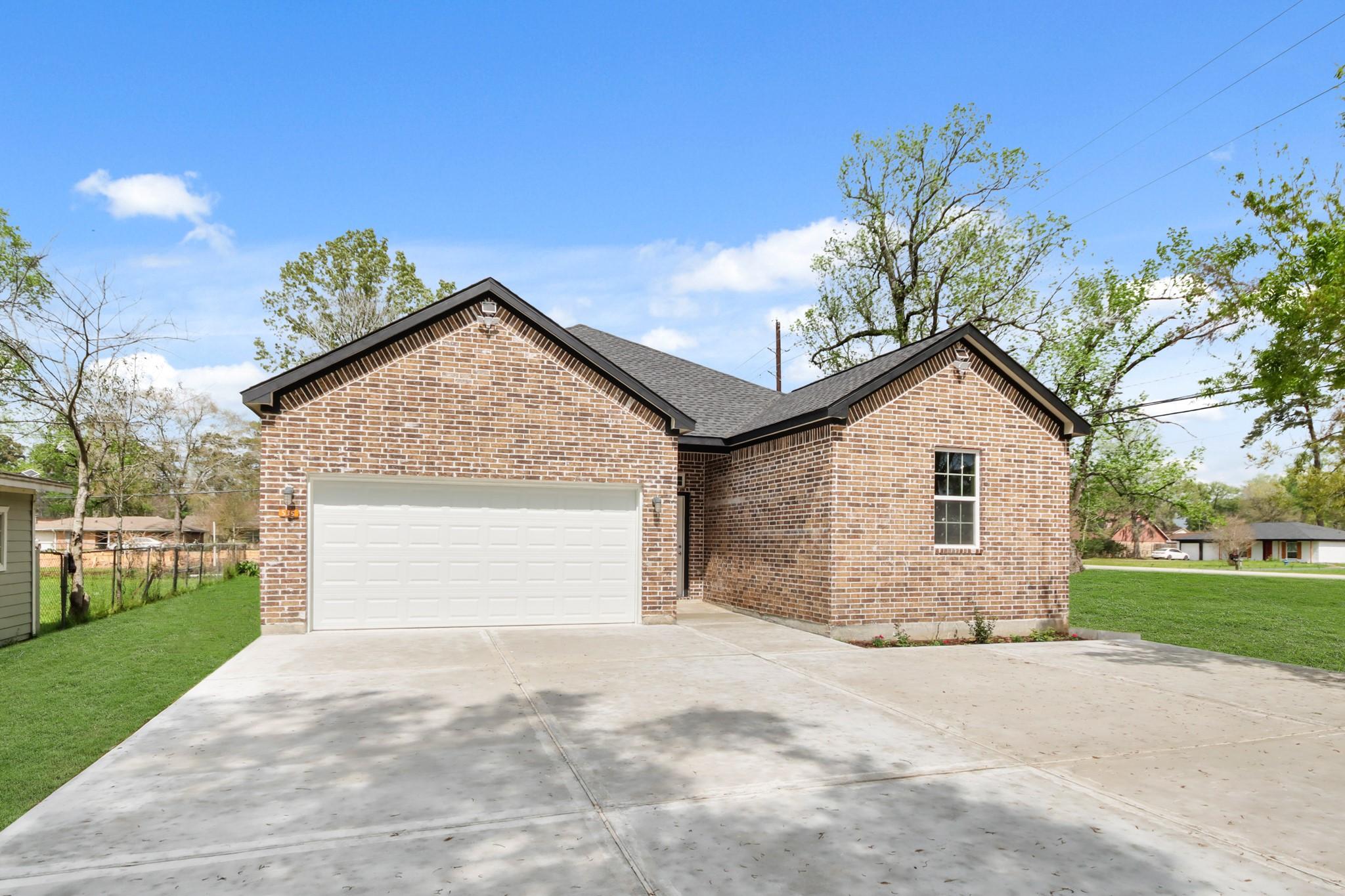 Image 4: This is a modern, single-story brick home with a s