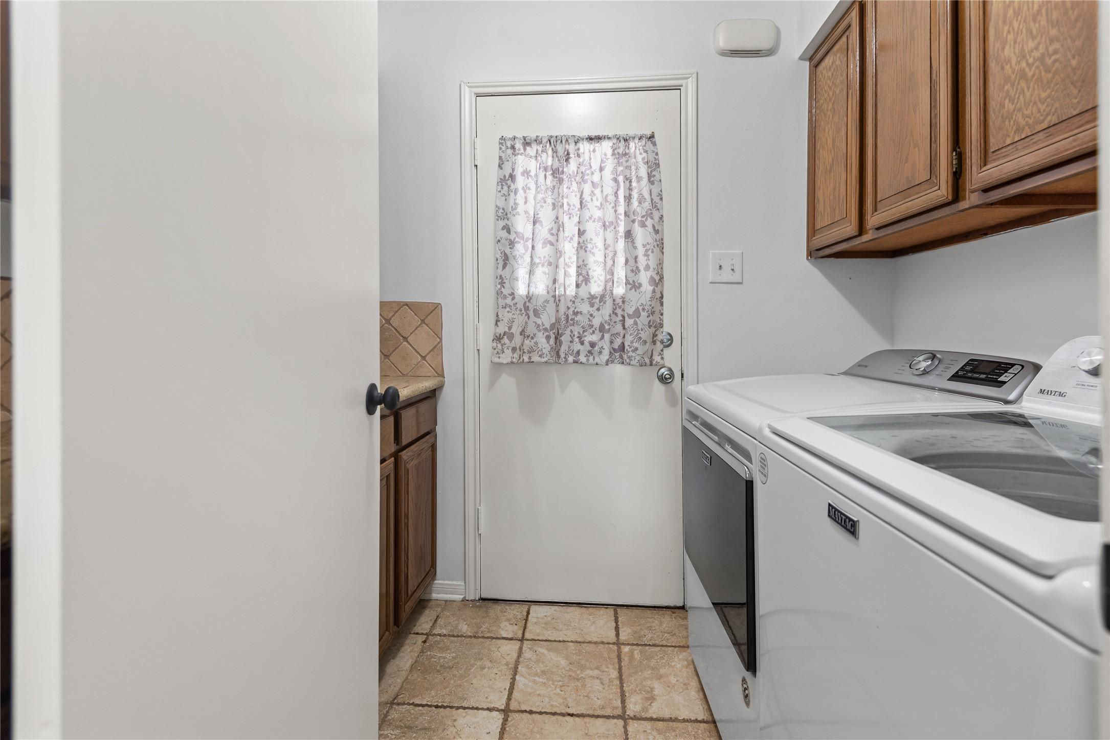 Image 4: Utility room with full-size washer and dryer, tile