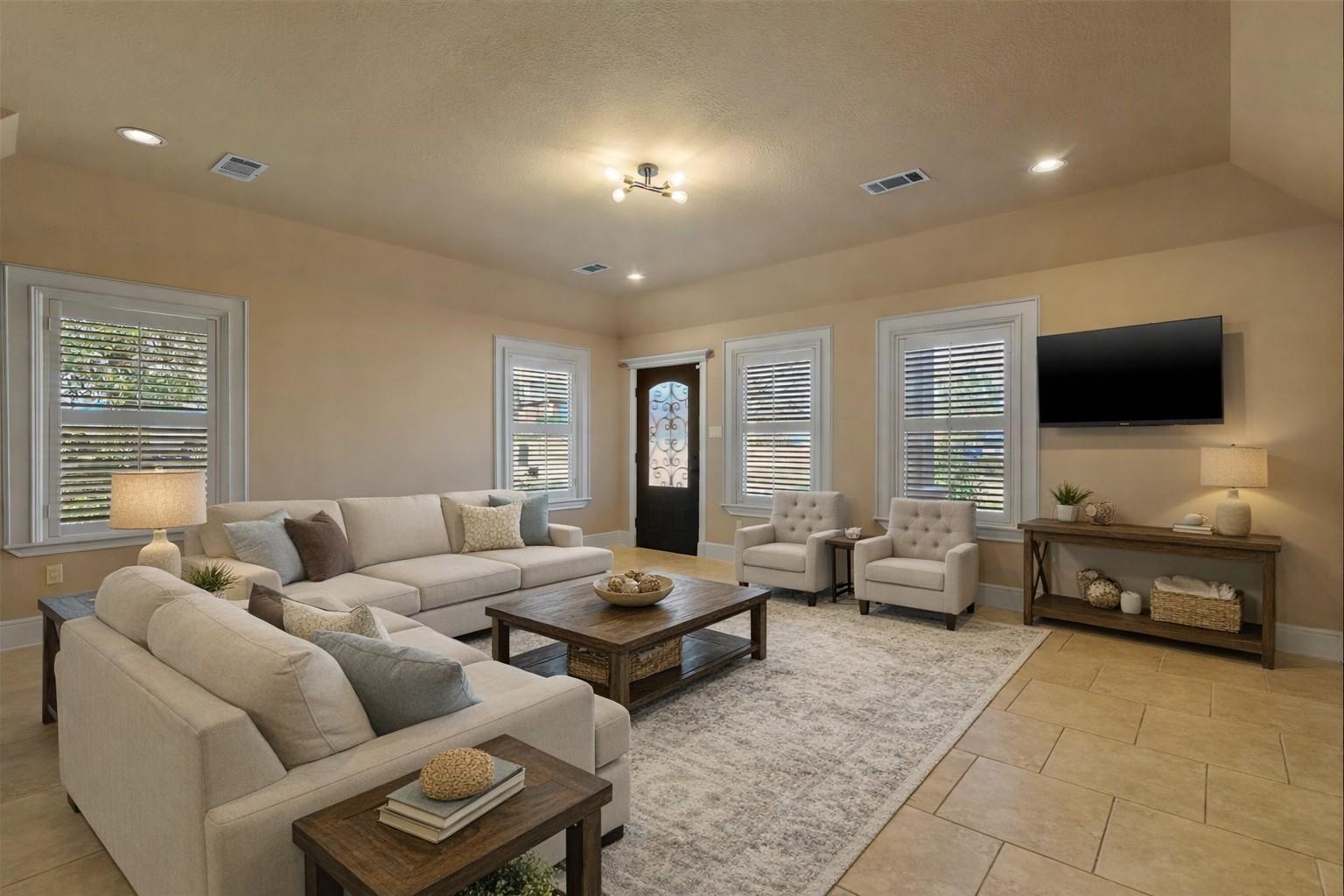Image 2: Spacious family room features tile floors, large p