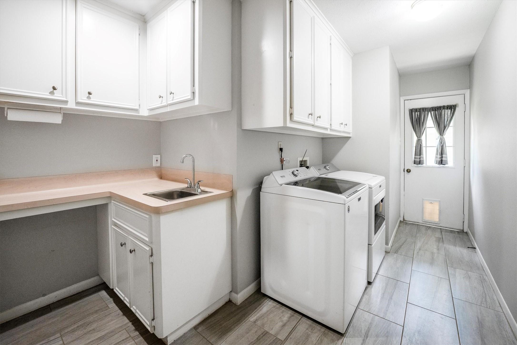 Image 4: Well-appointed laundry room with ample counter spa