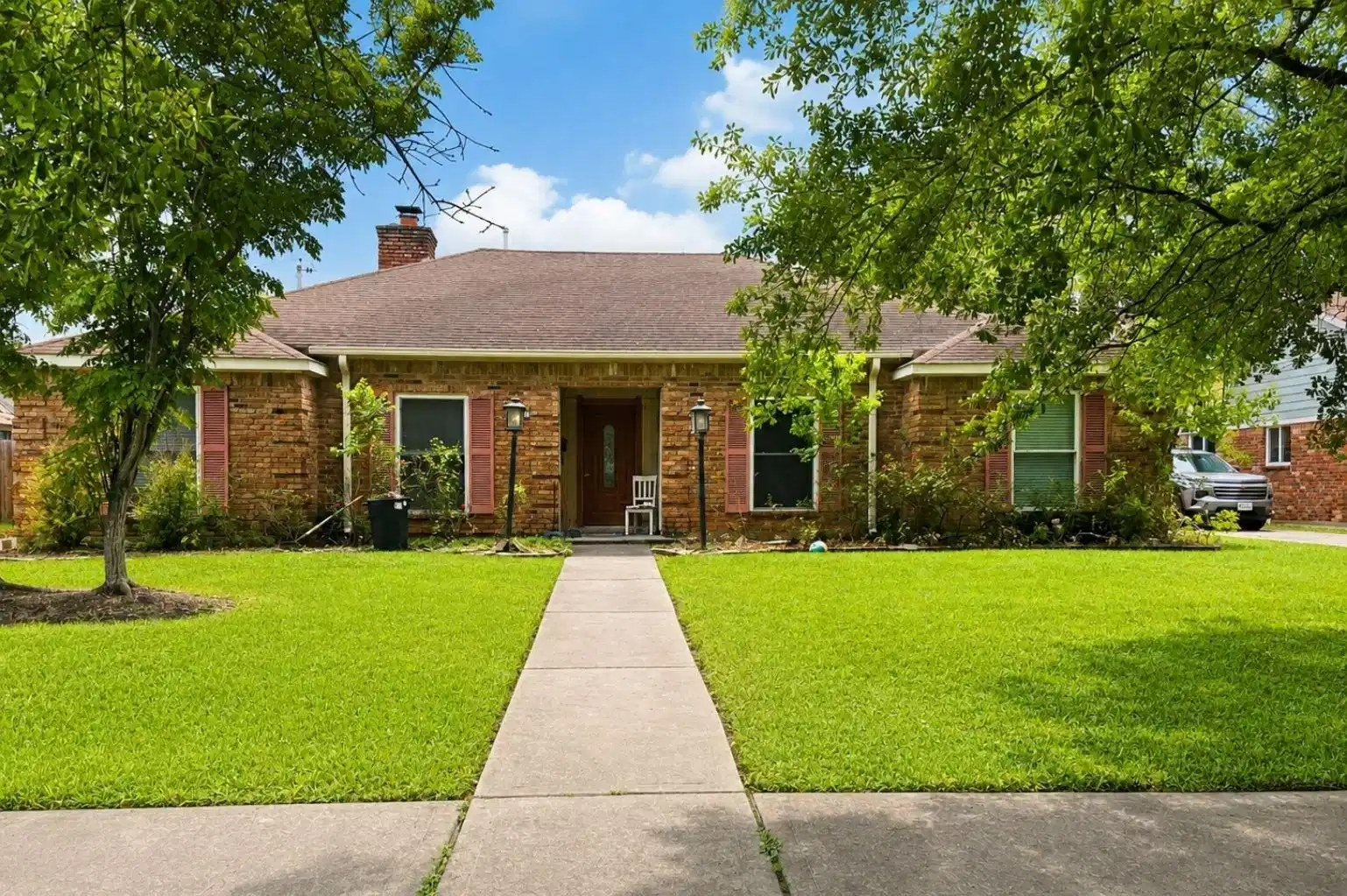 Image 1: Charming brick ranch-style home with a welcoming f