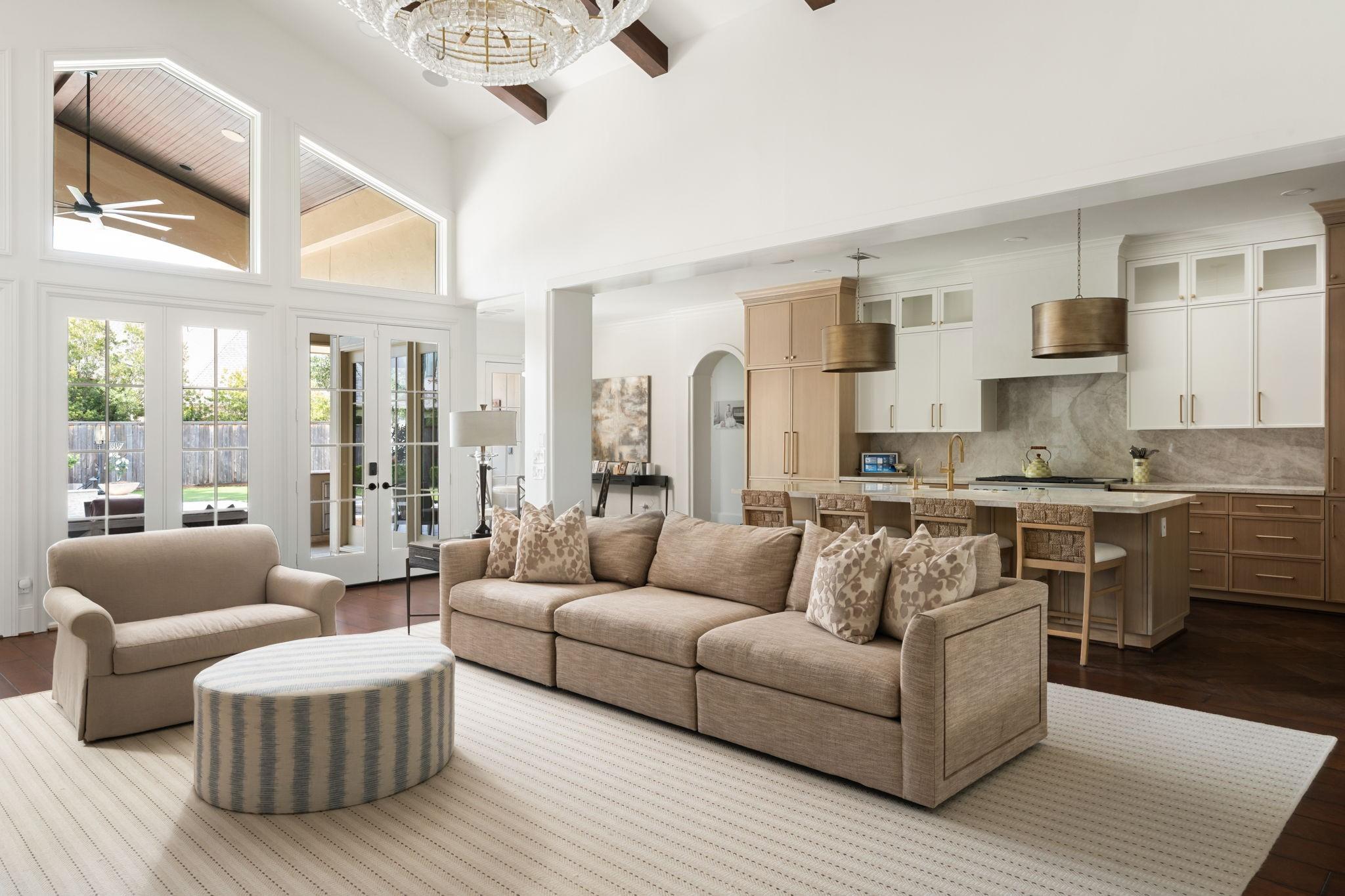 Image 2: The great room features soaring ceilings, expansiv
