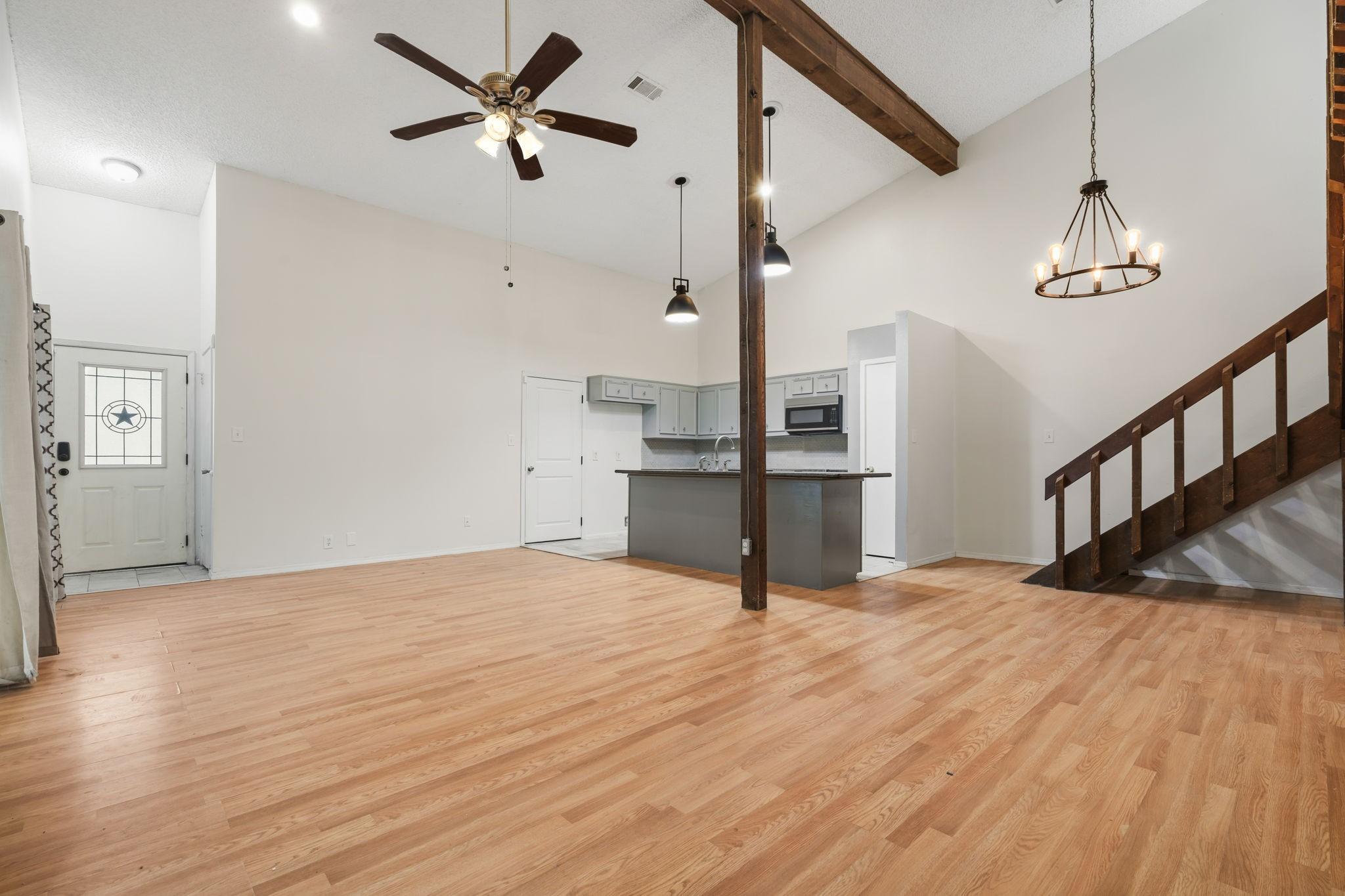 Image 3: Expansive living area with high ceilings and abund