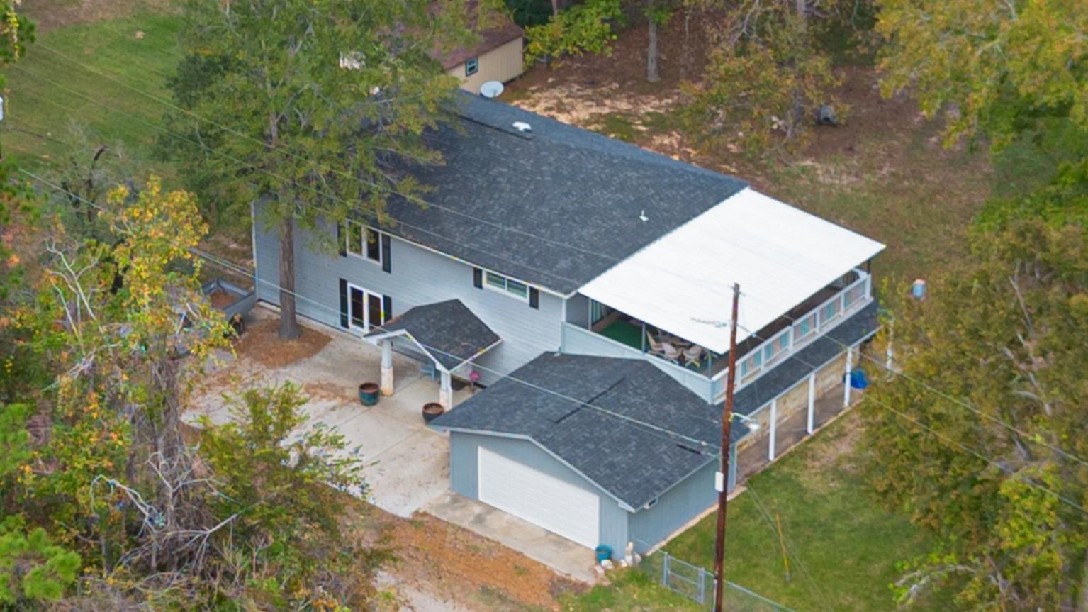Image 4: Spacious 2-story home surrounded by mature trees p
