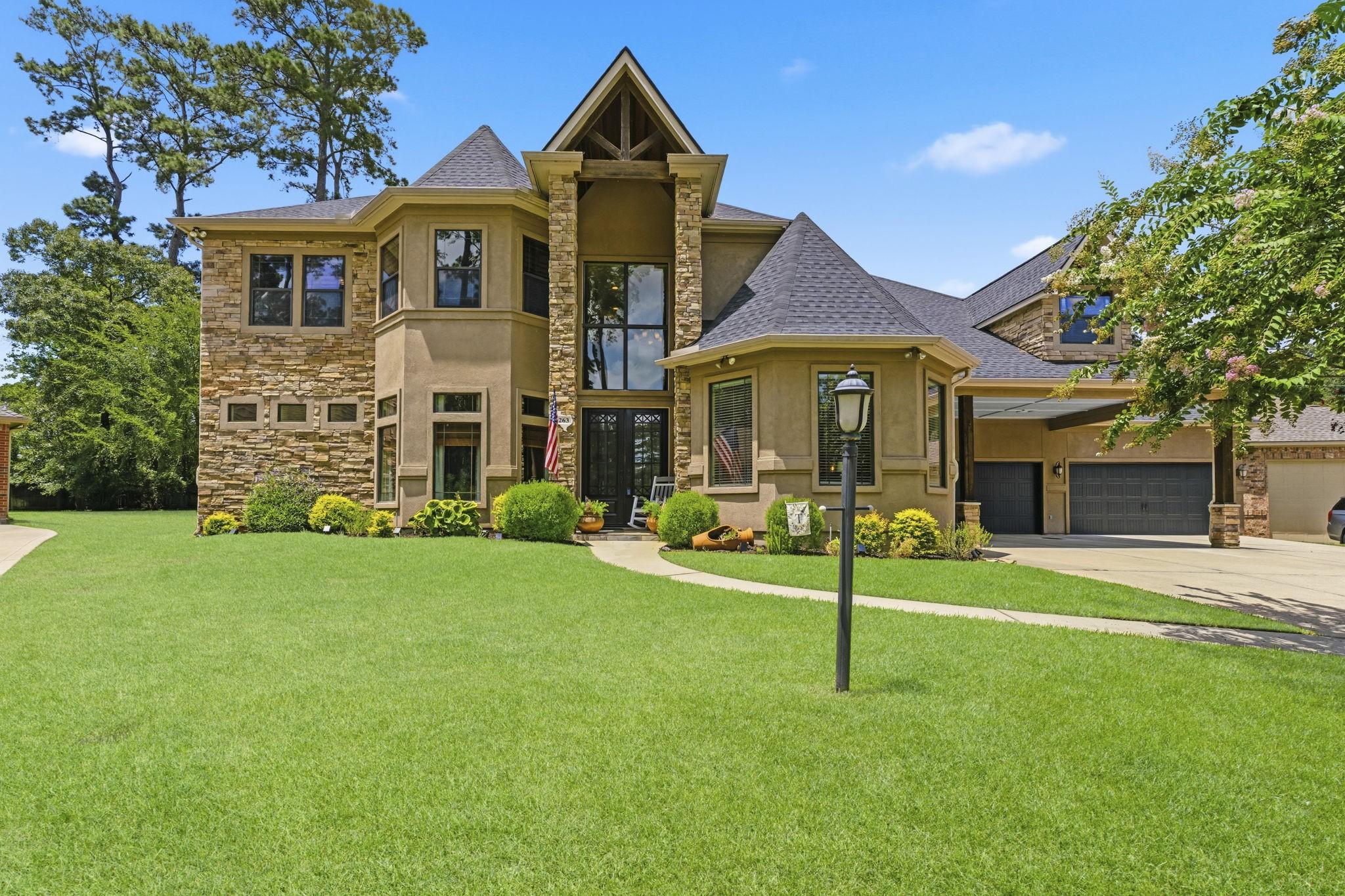 Image 3: Stunning custom exterior featuring stacked stone,