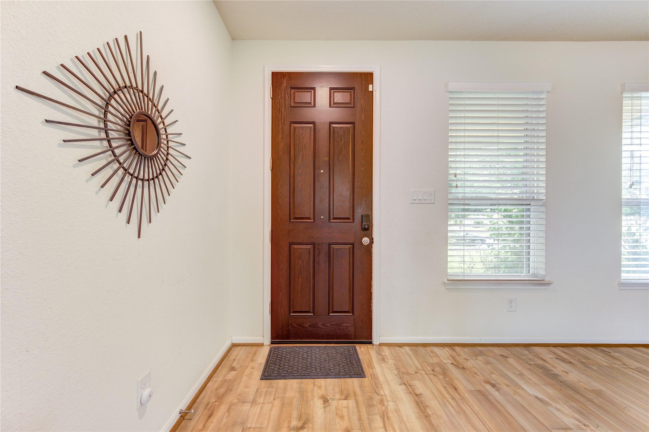 Image 4: Step inside to a welcoming entry that opens to an