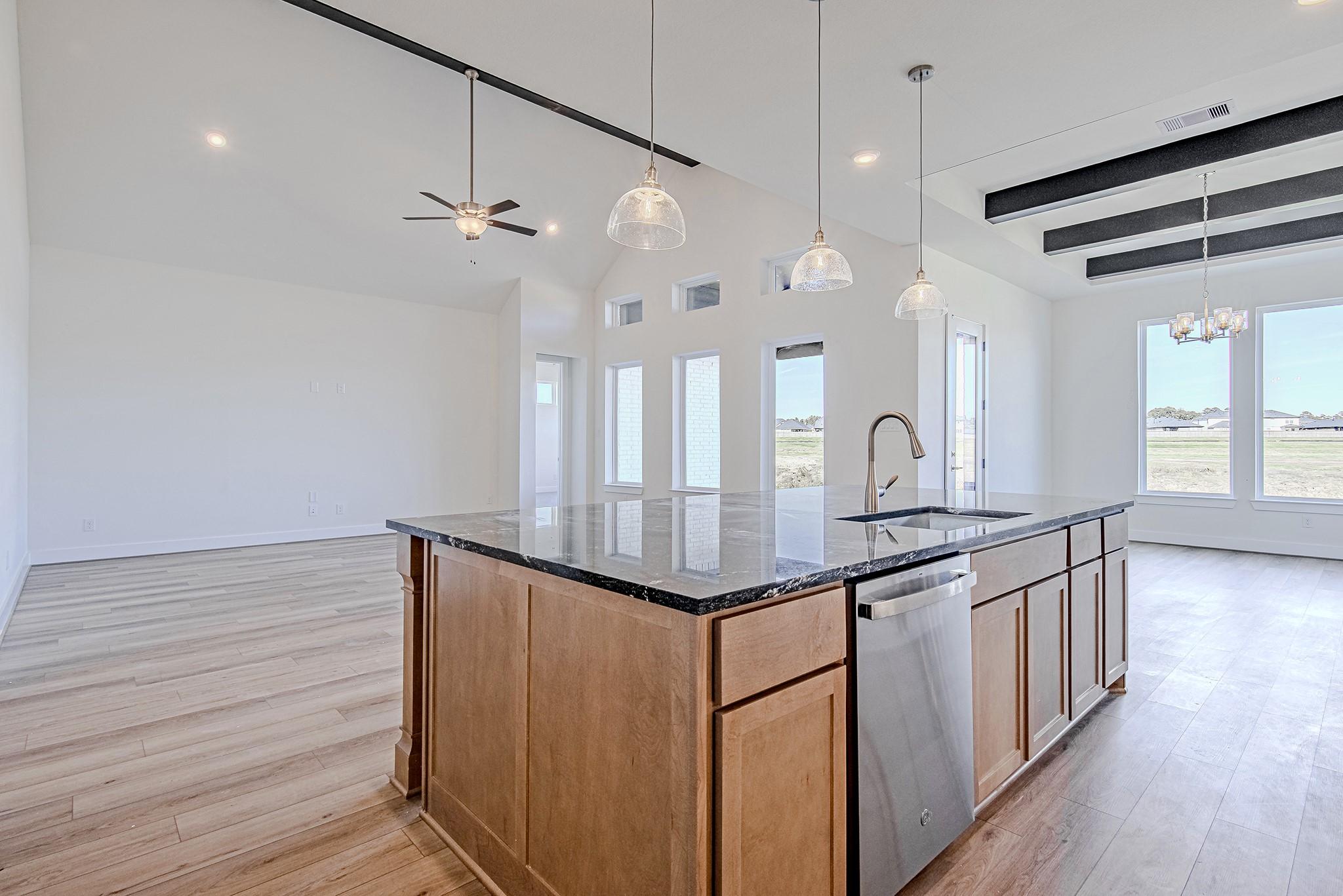 Image 4: Kitchen island overlooking the main living space,