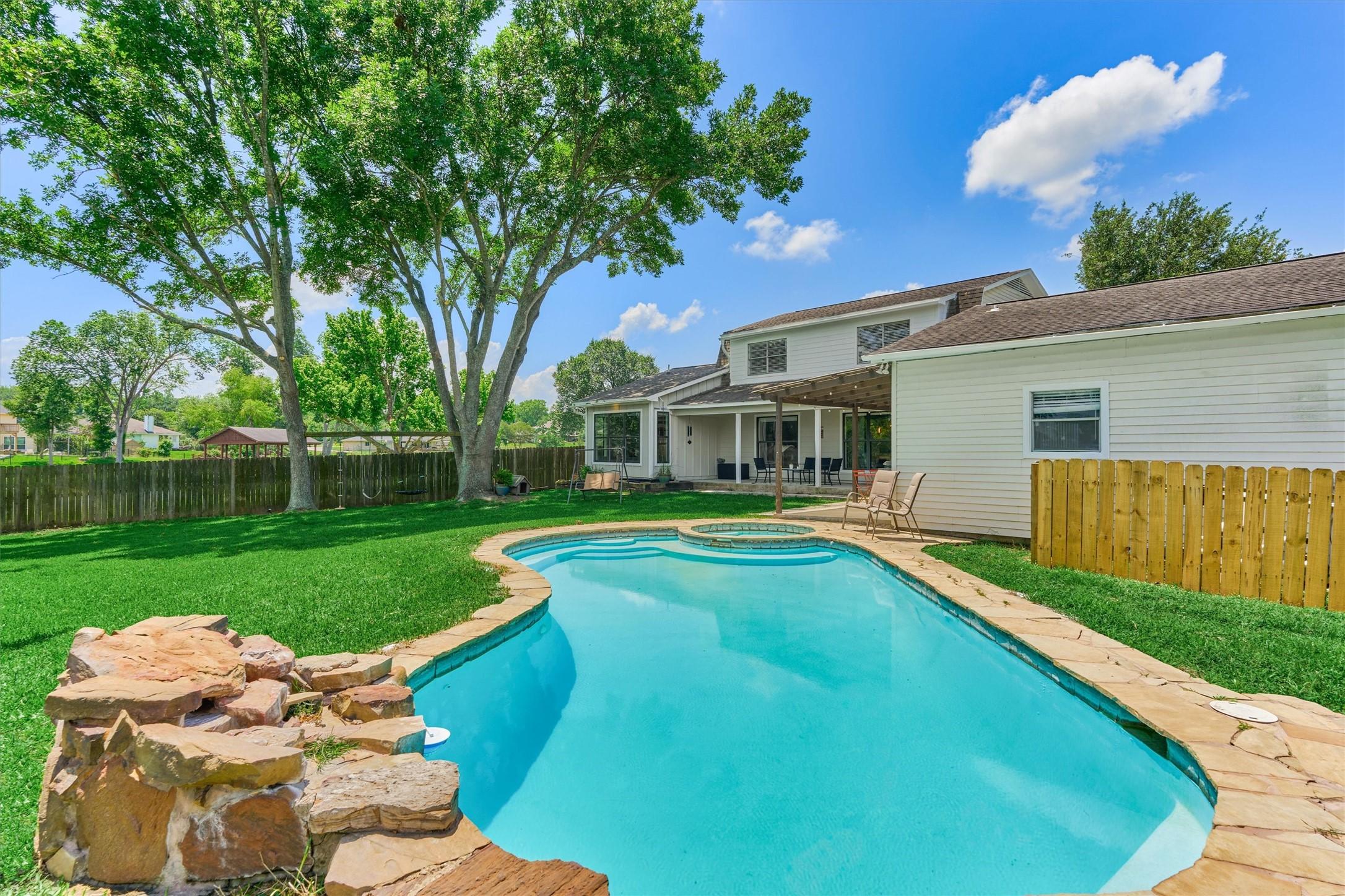 Image 4: The backyard oasis is anchored by a sparkling 10,0