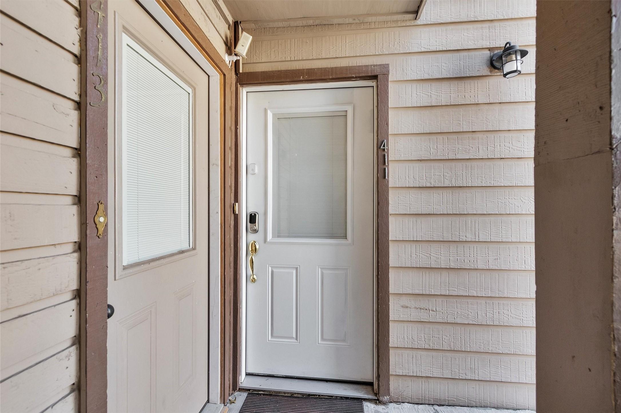 Image 2: This inviting entryway, with its glass-paneled doo