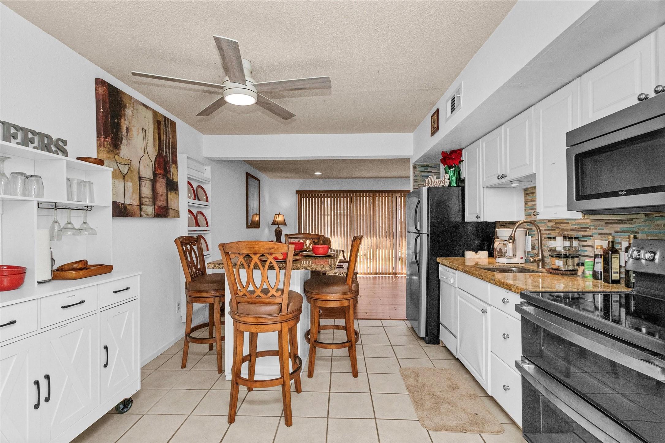 Image 4: This inviting kitchen and dining area boasts white