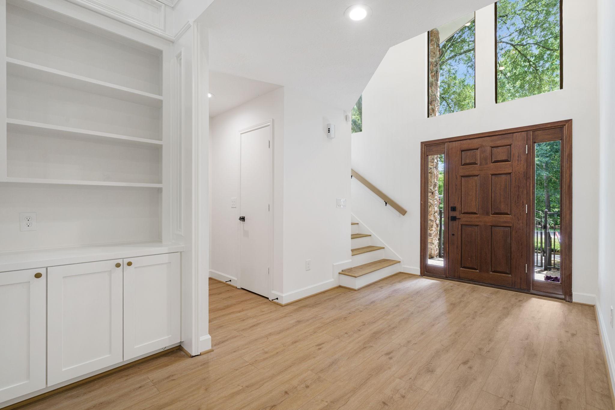 Image 3: A beautiful foyer welcomes you with high ceilings,