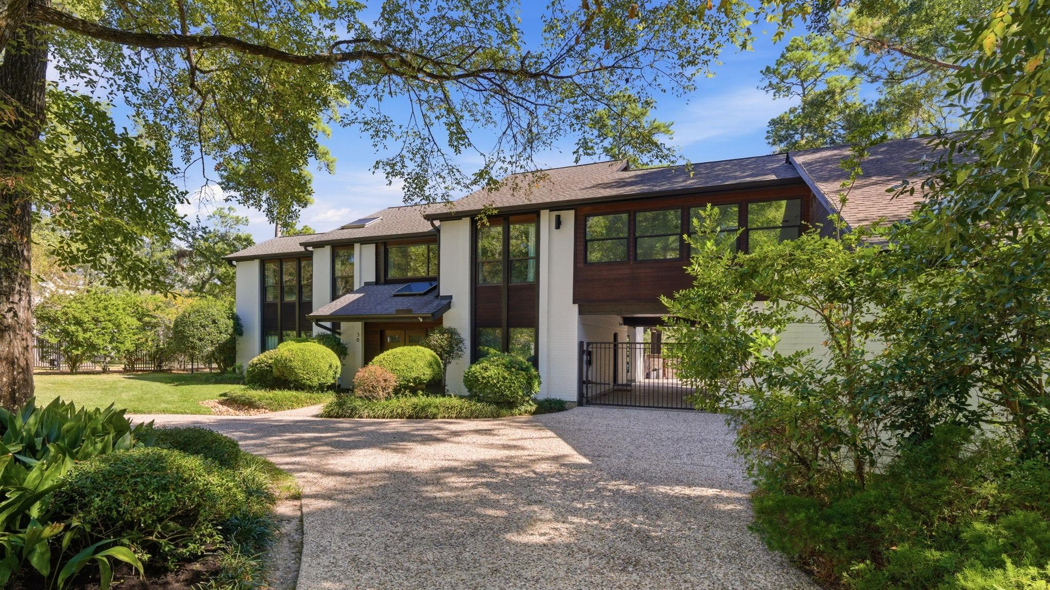 Image 2: A circular drive with a gated motor court adds pri