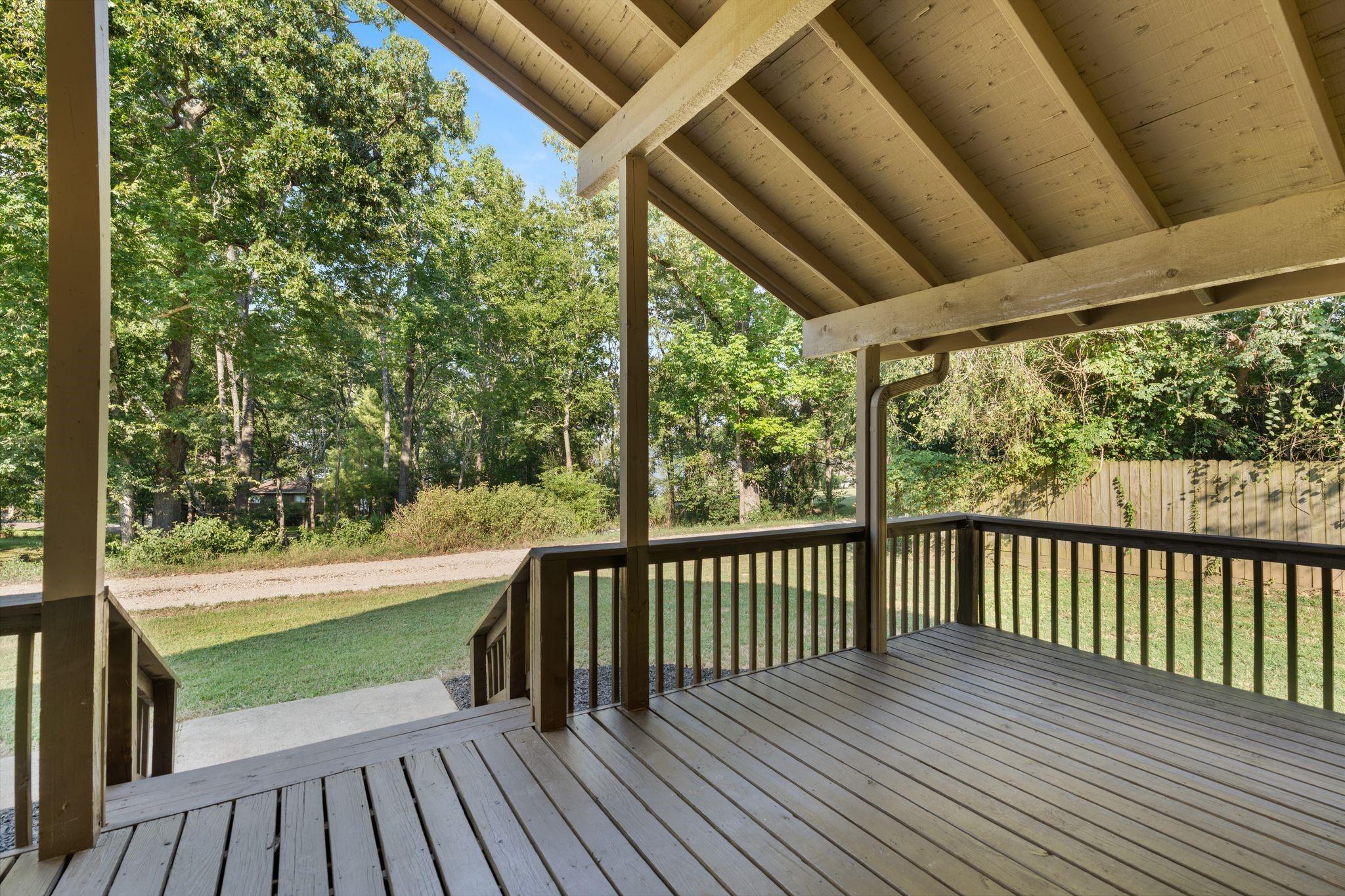Image 2: Deep front porch faces the lake