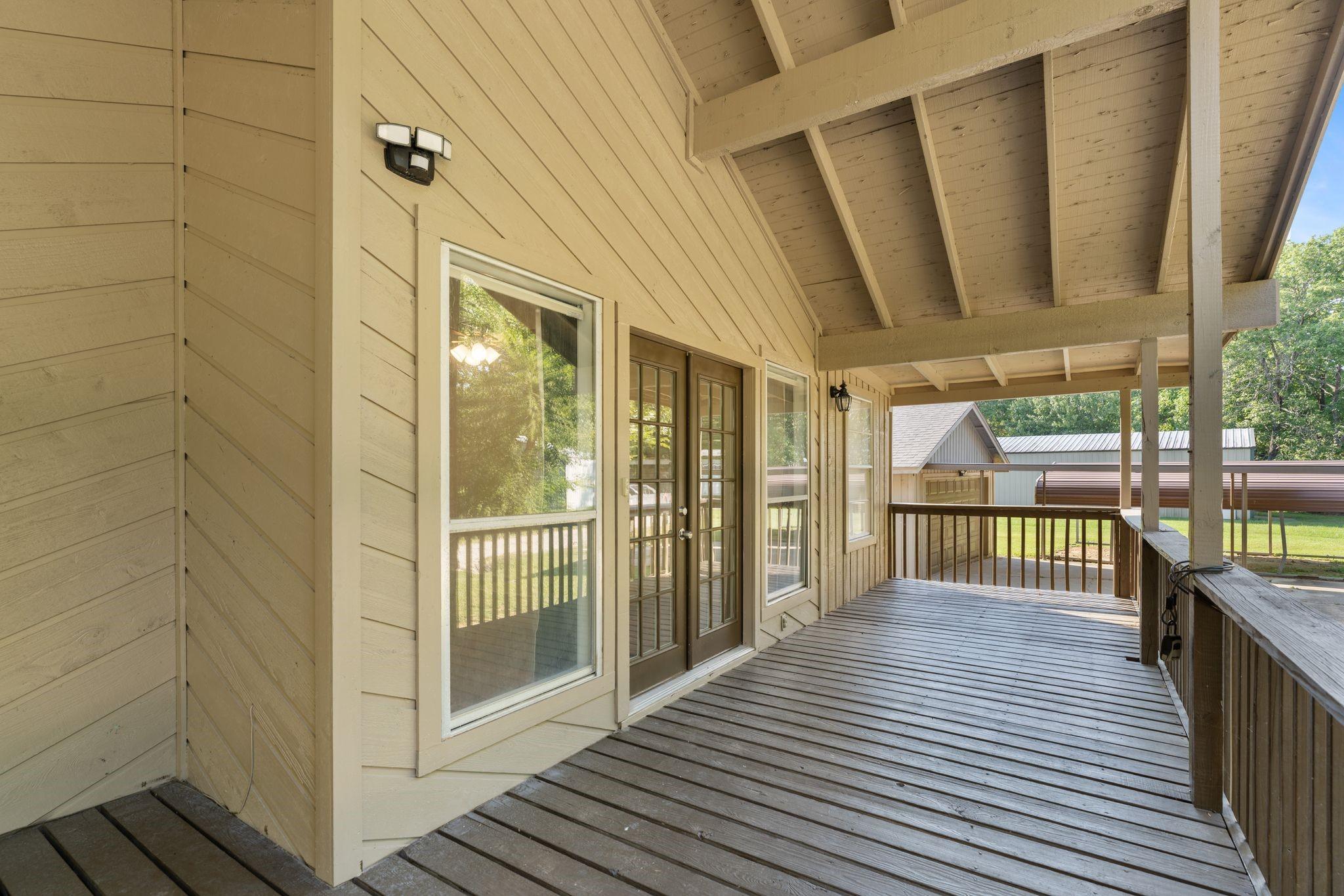 Image 3: Porch spans the width of the home