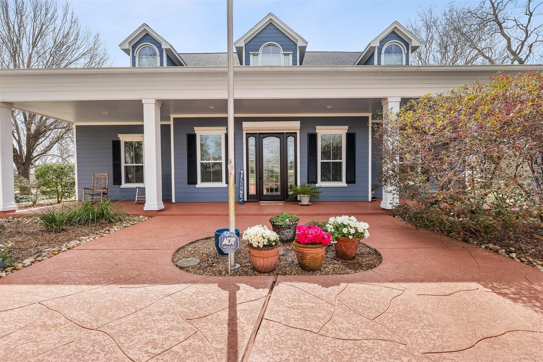 Image 2: The beautiful covered front porch welcomes you hom