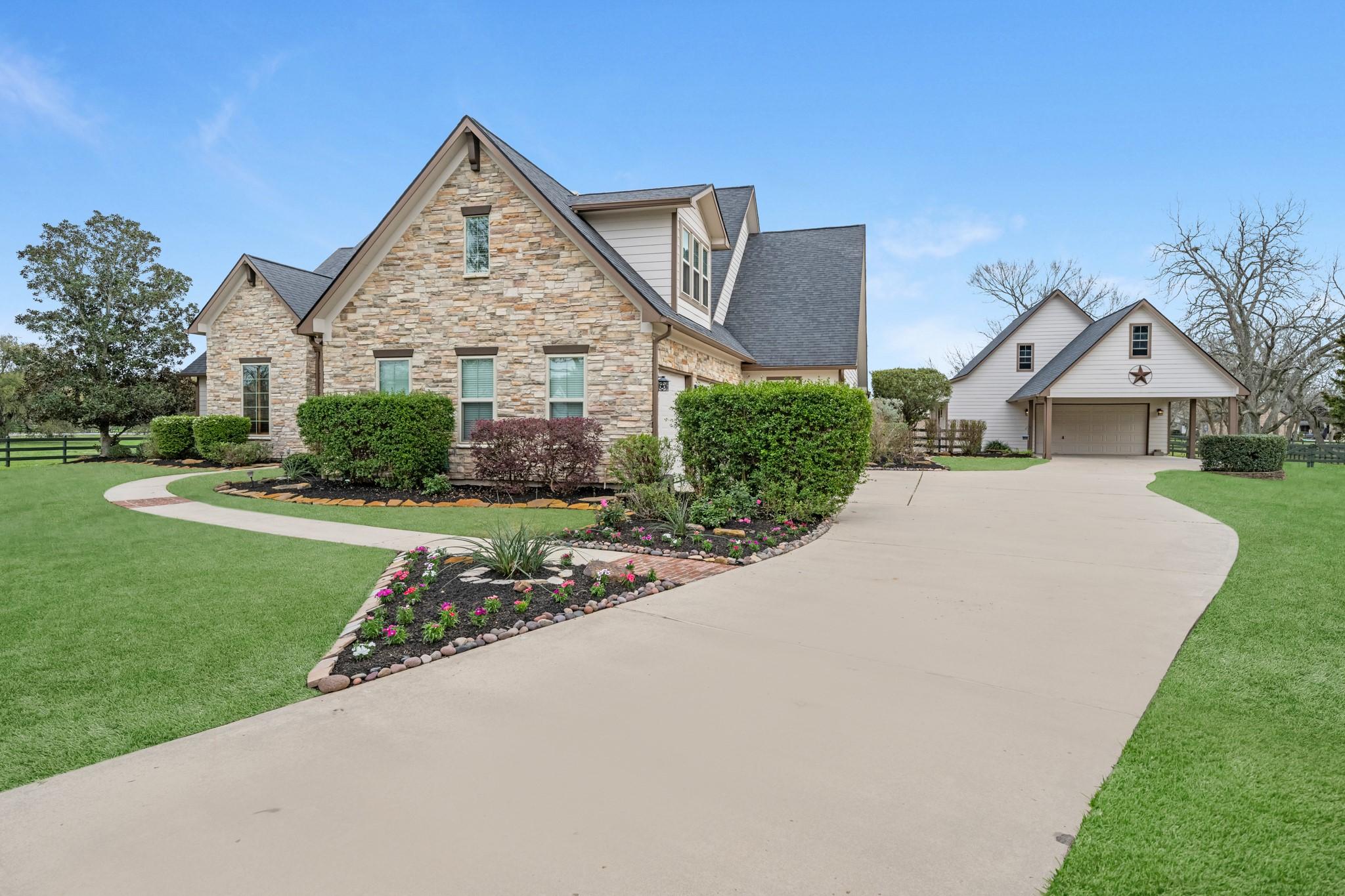 Image 3: An extended private driveway welcomes you home whi