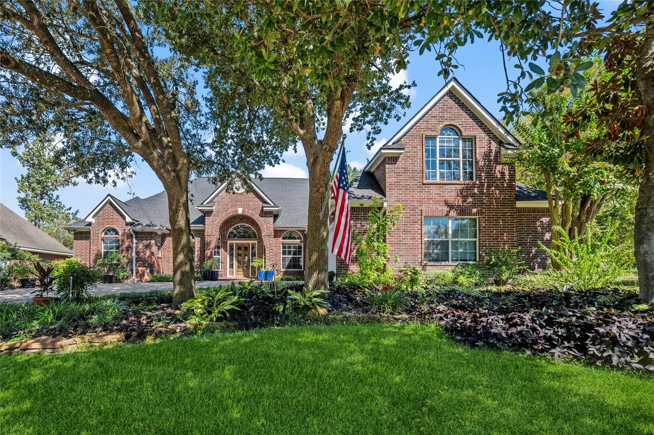 Image 1: This picturesque brick home features a well-mainta