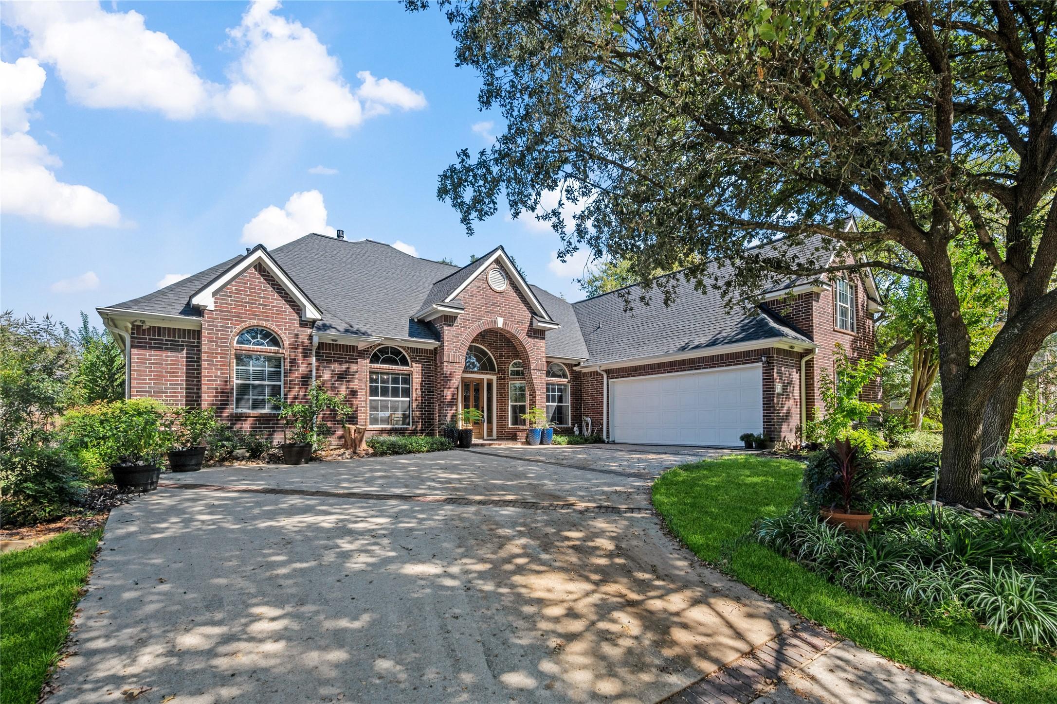 Image 3: This charming brick home features a spacious two-c