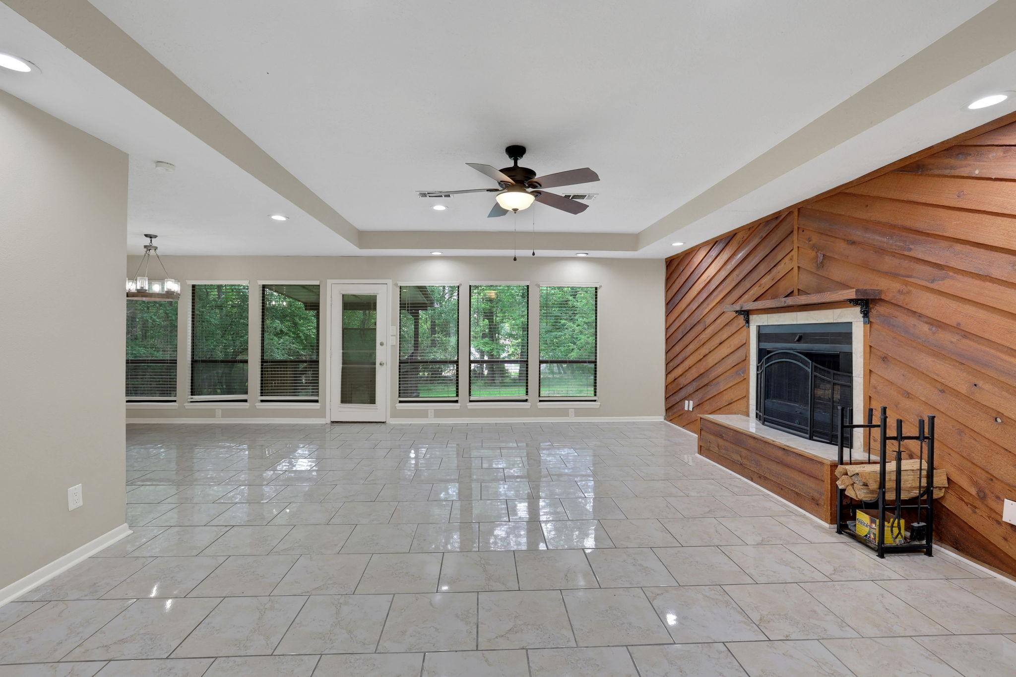 Image 2: Bright living room with fireplace and wall of wind