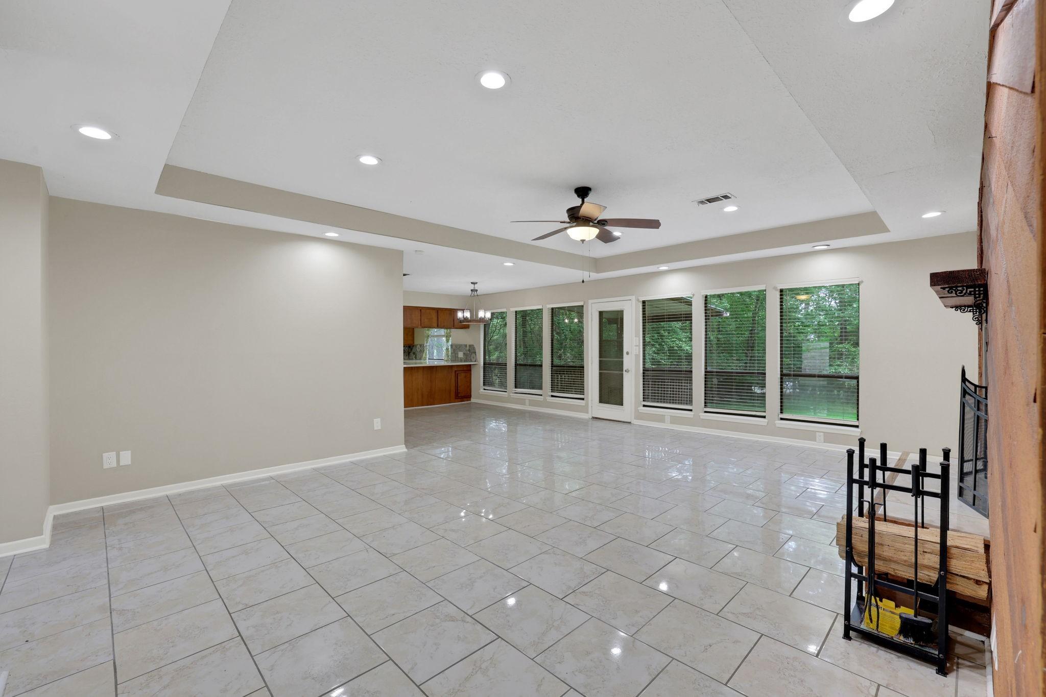 Image 3: Spacious open-concept living with fireplace & wood