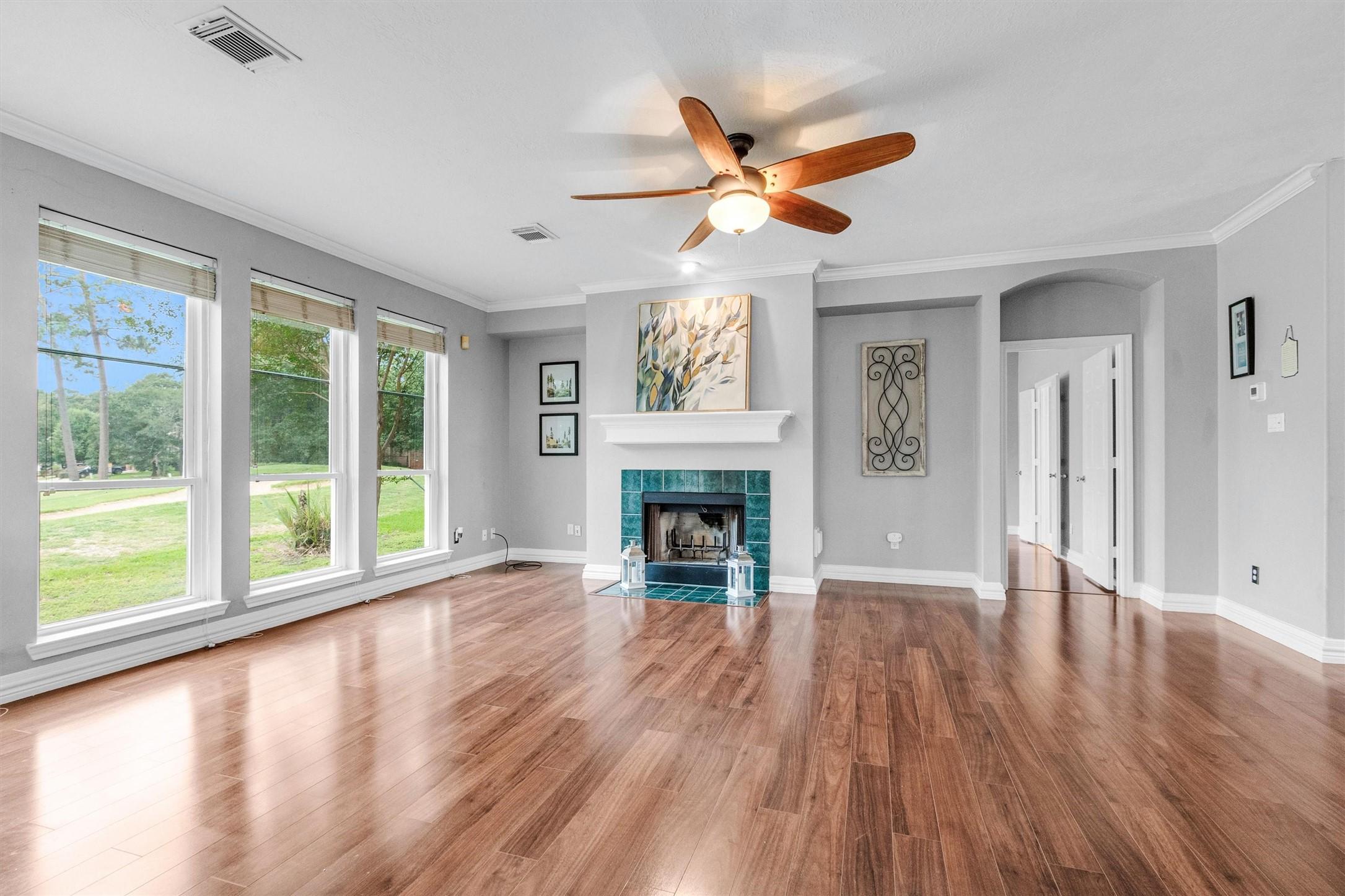 Image 4: This spacious living room features large windows f