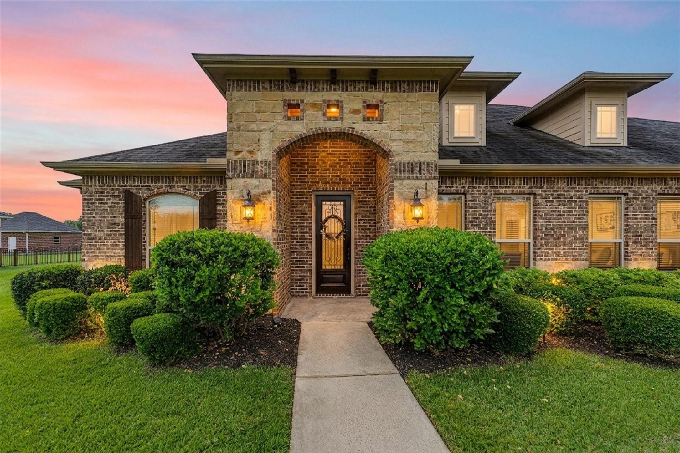 Image 2: Beautiful brick and stone entry way welcomes you.
