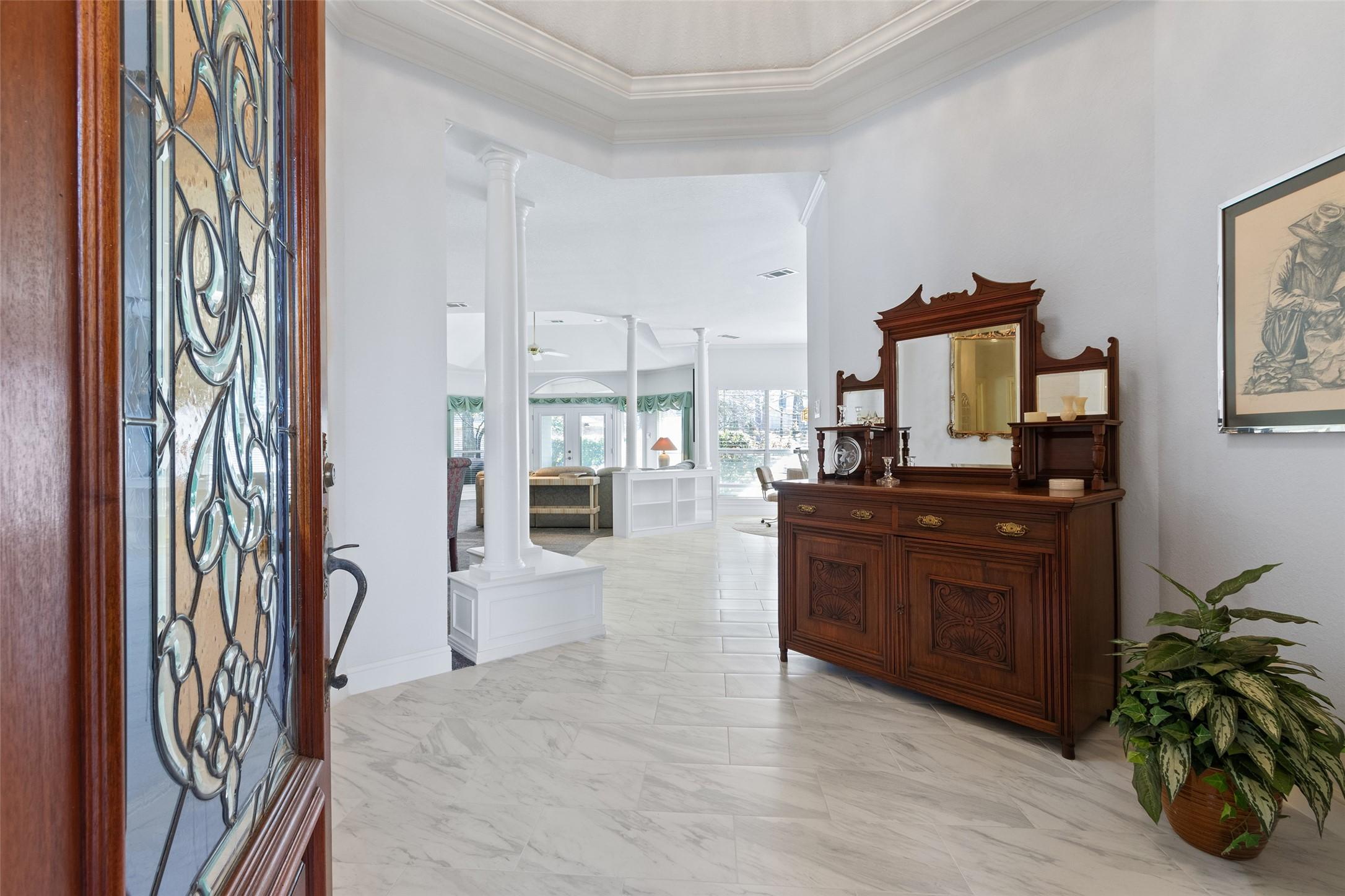 Image 3: An elegant formal entry welcomes guests to this st