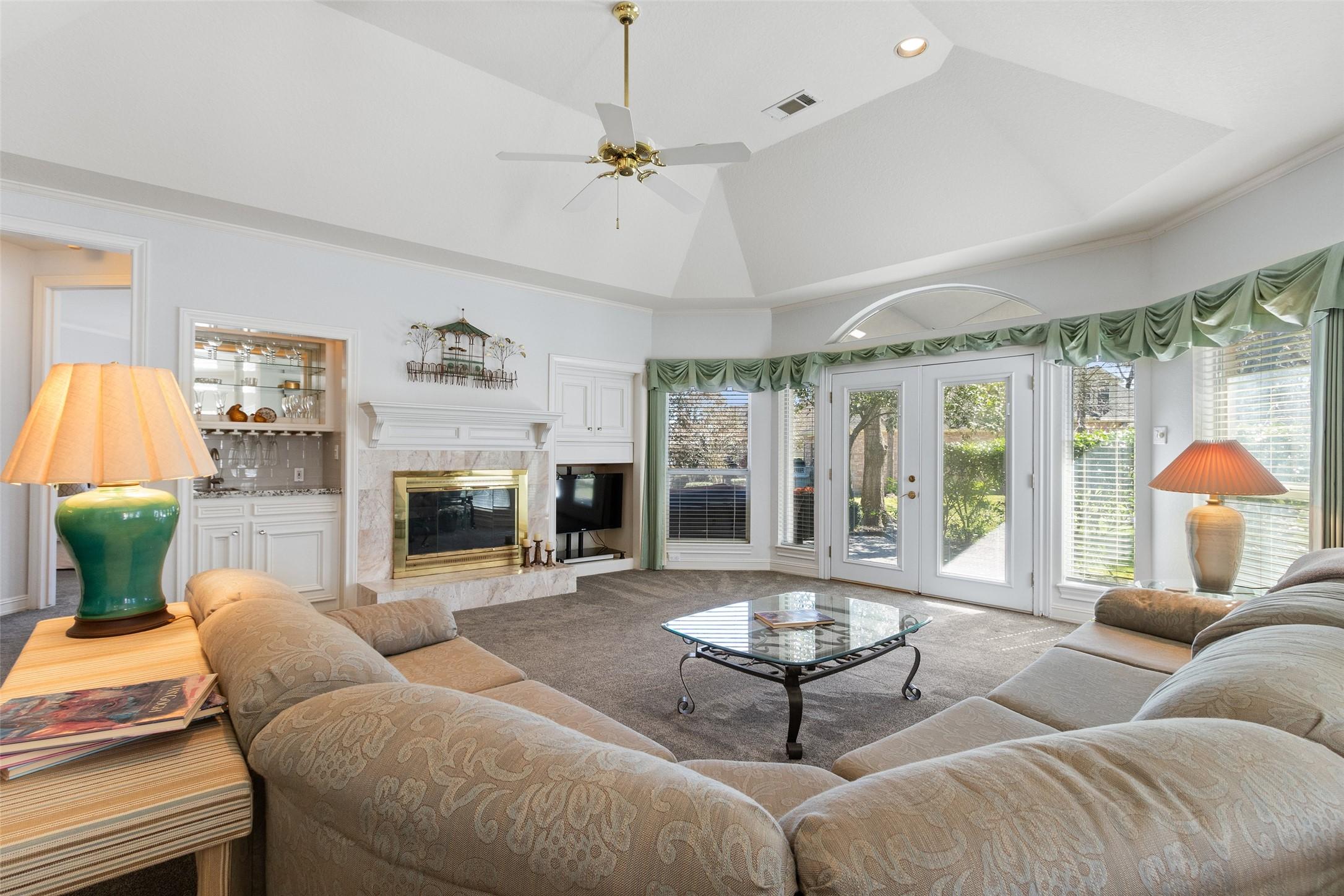 Image 4: Spacious living area boasts a cozy fireplace flank