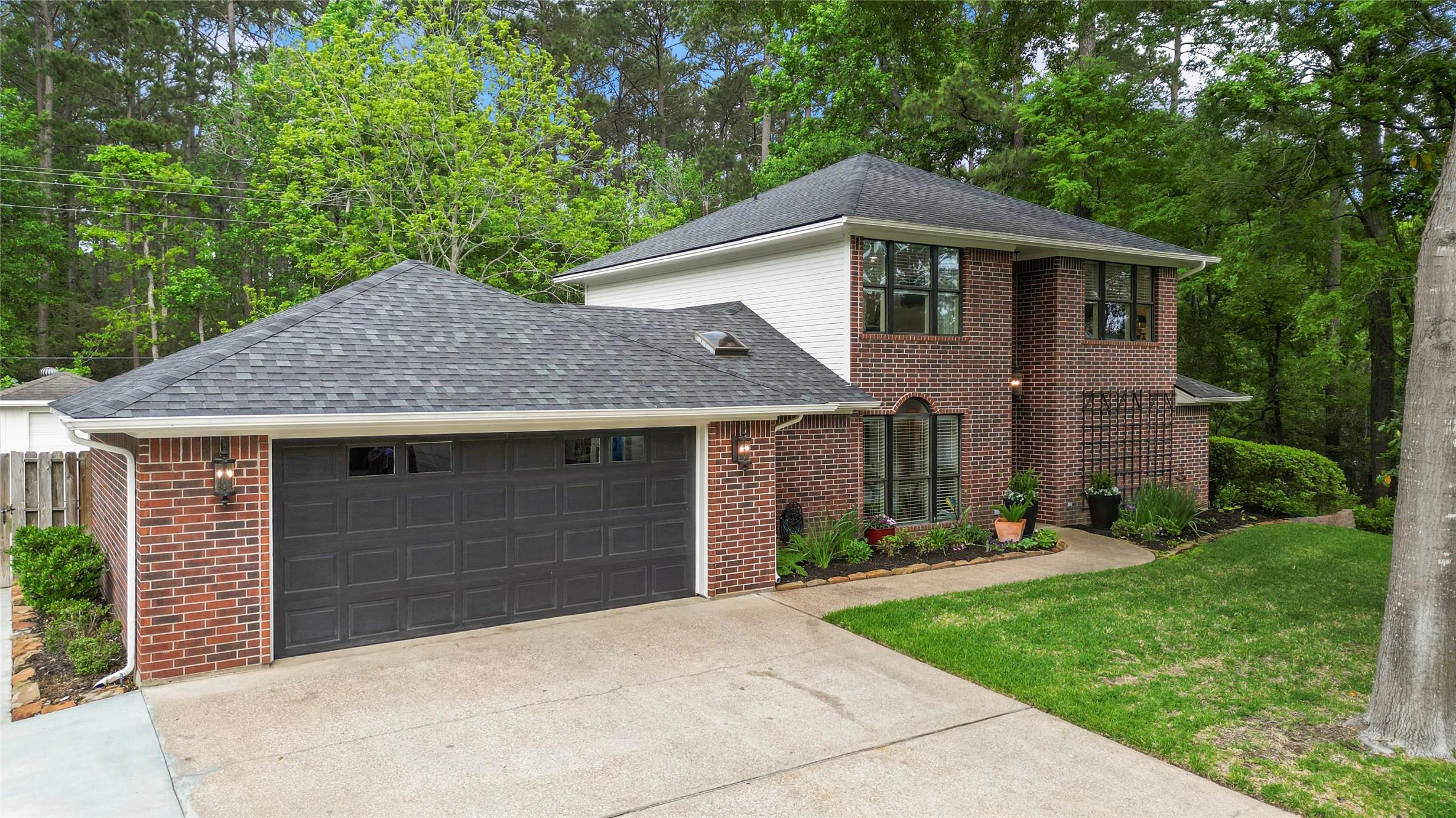 Image 1: This inviting two-story brick home features a well