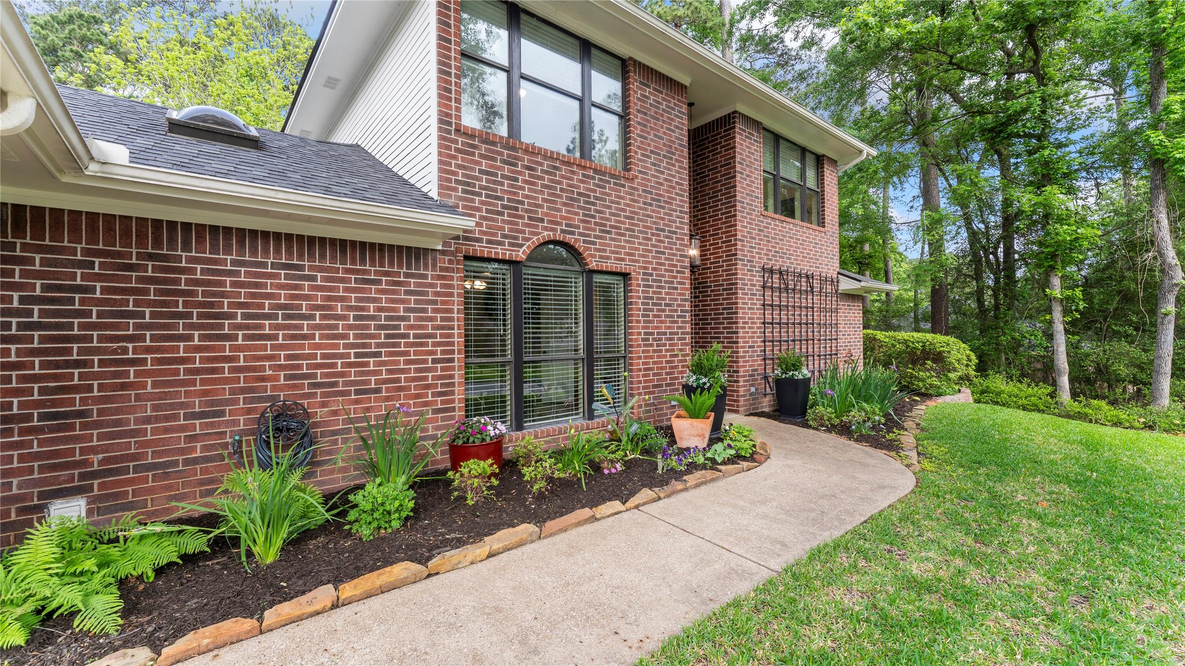 Image 2: This home showcases a charming two-story brick hom