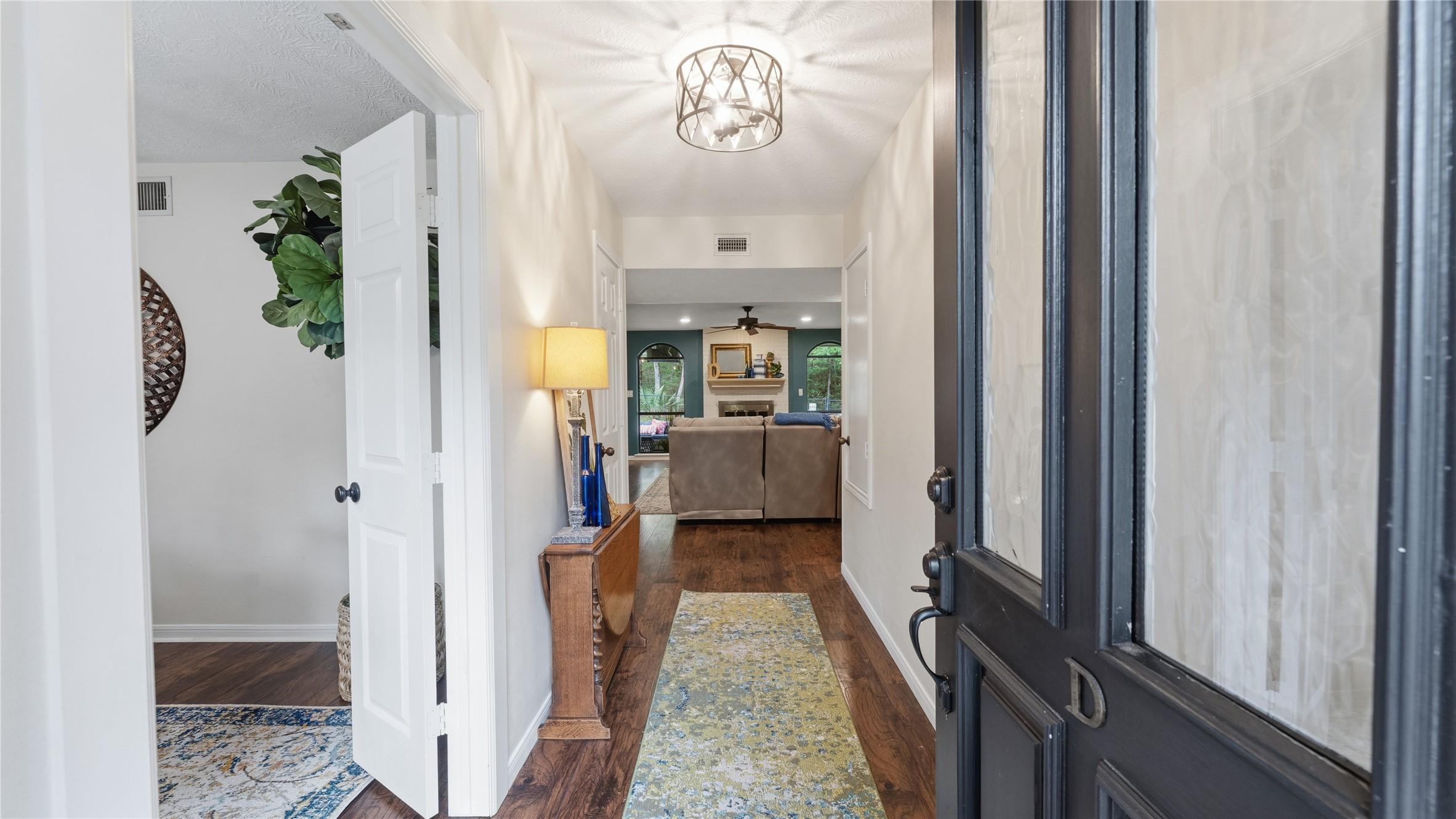 Image 4: This inviting entryway features warm wood like flo