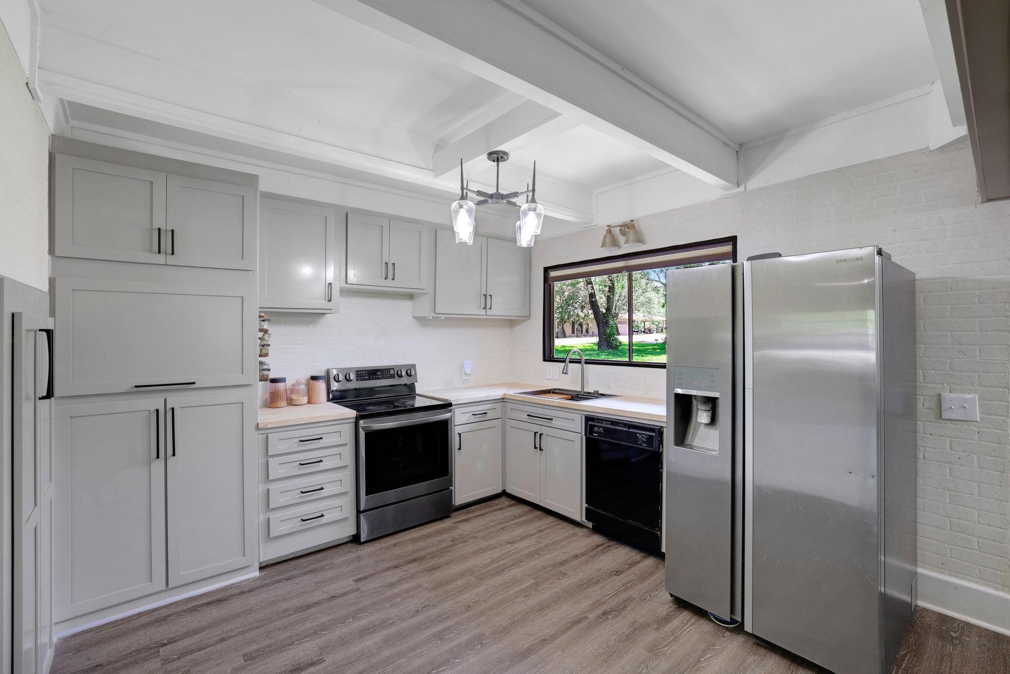 Image 4: The kitchen has been nicely updated with new cabin