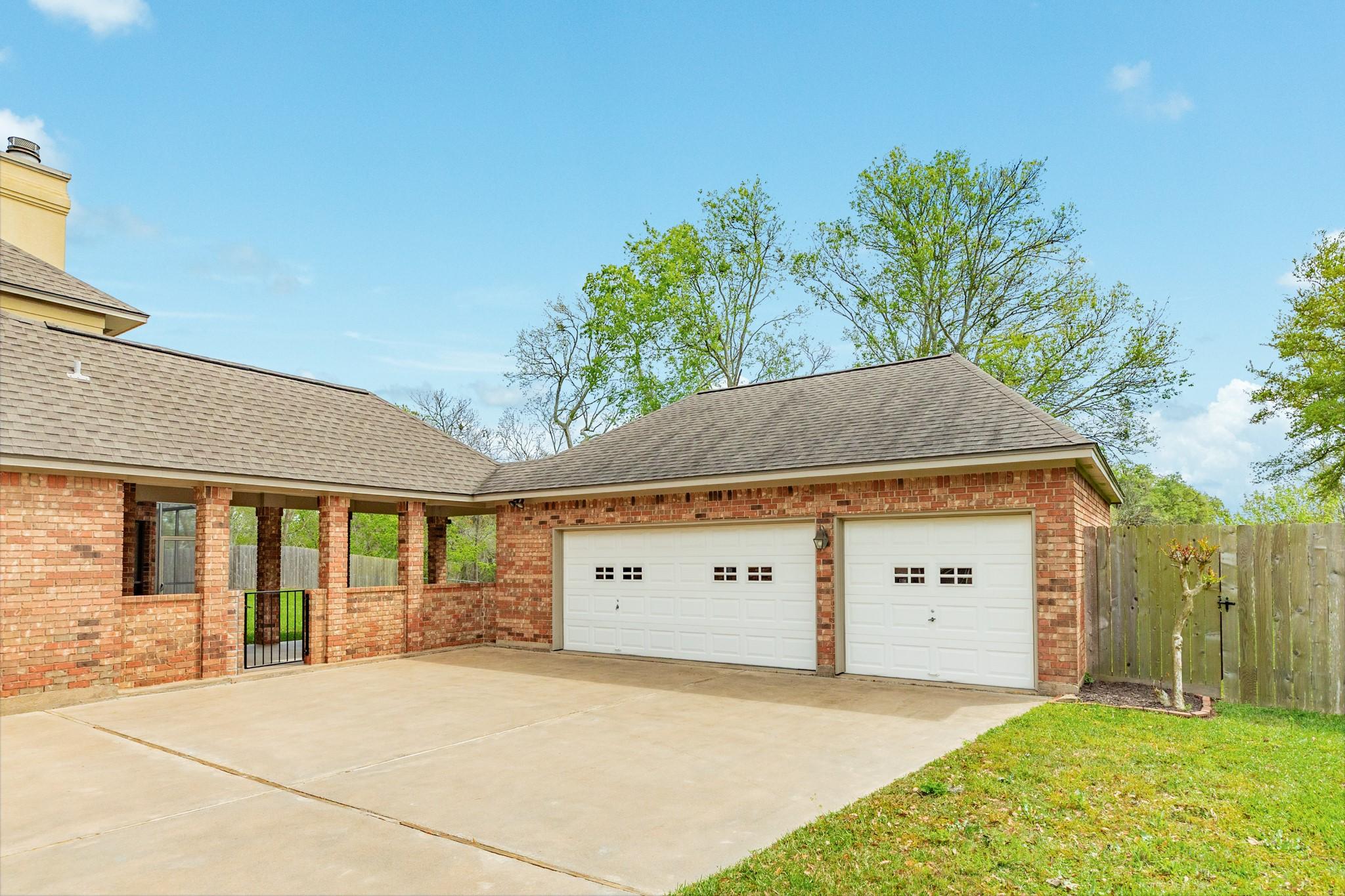 Image 4: Spacious triple-car garage with a triple-wide conc