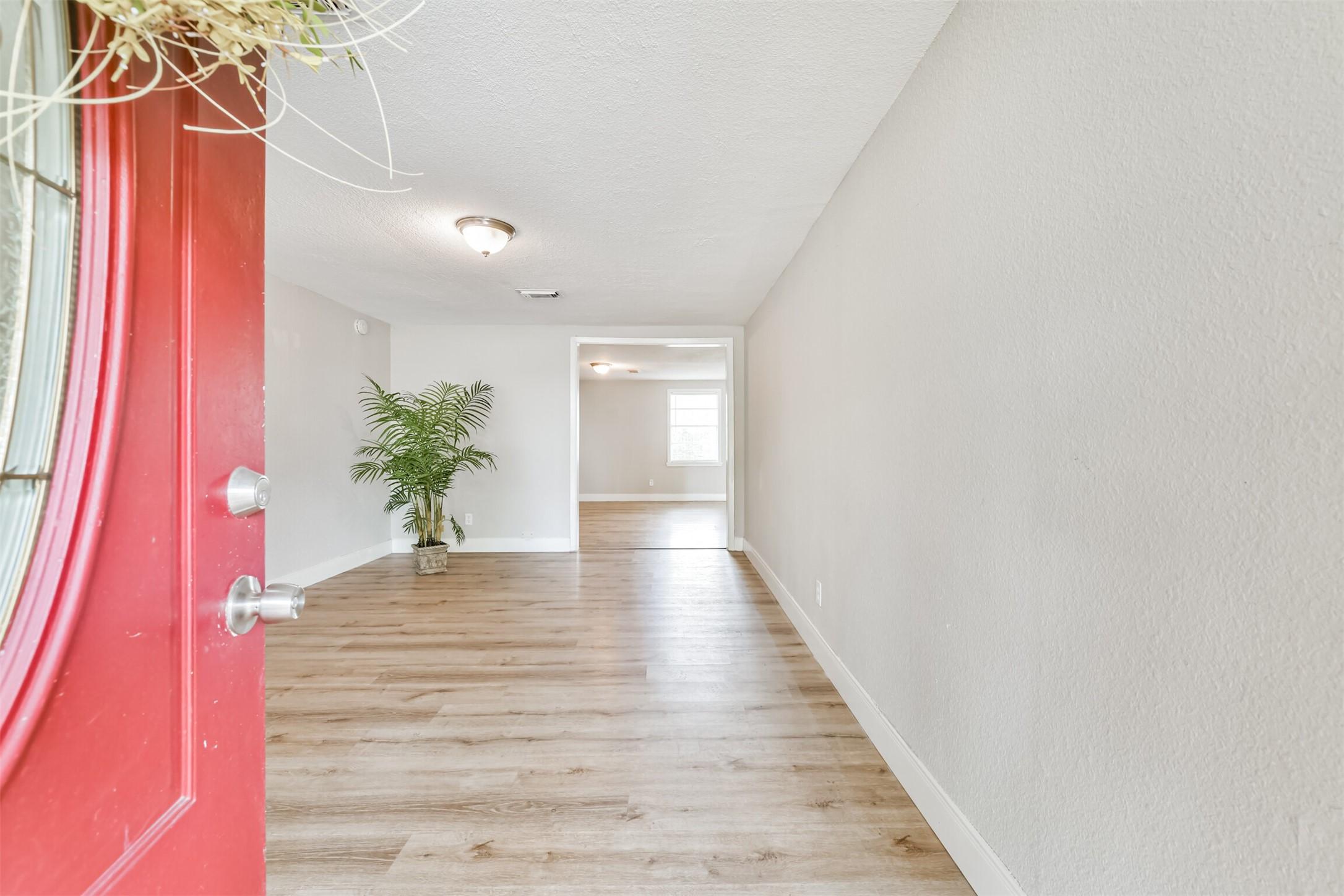 Image 4: This photo shows a bright and inviting entryway wi