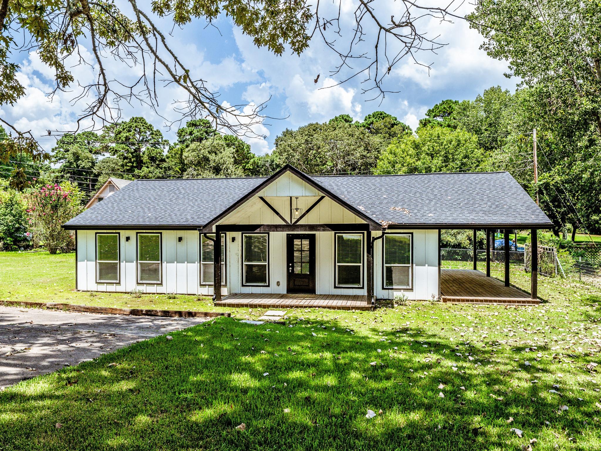 Image 1: Charming ranch-style home with a modern exterior,