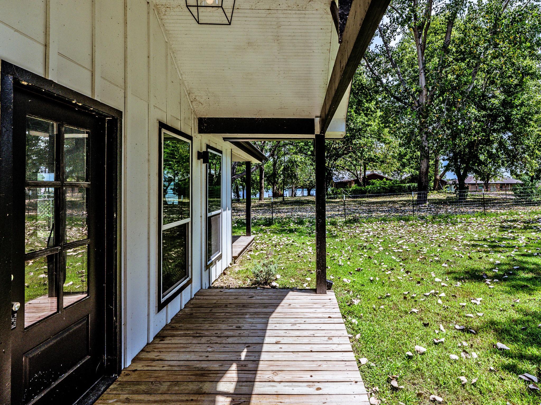 Image 4: Charming home with a covered wooden porch overlook