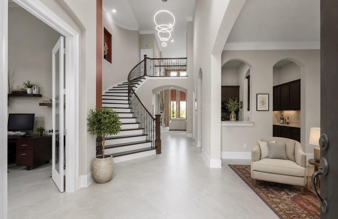 Image 2: Grand two-story foyer featuring a sweeping curved