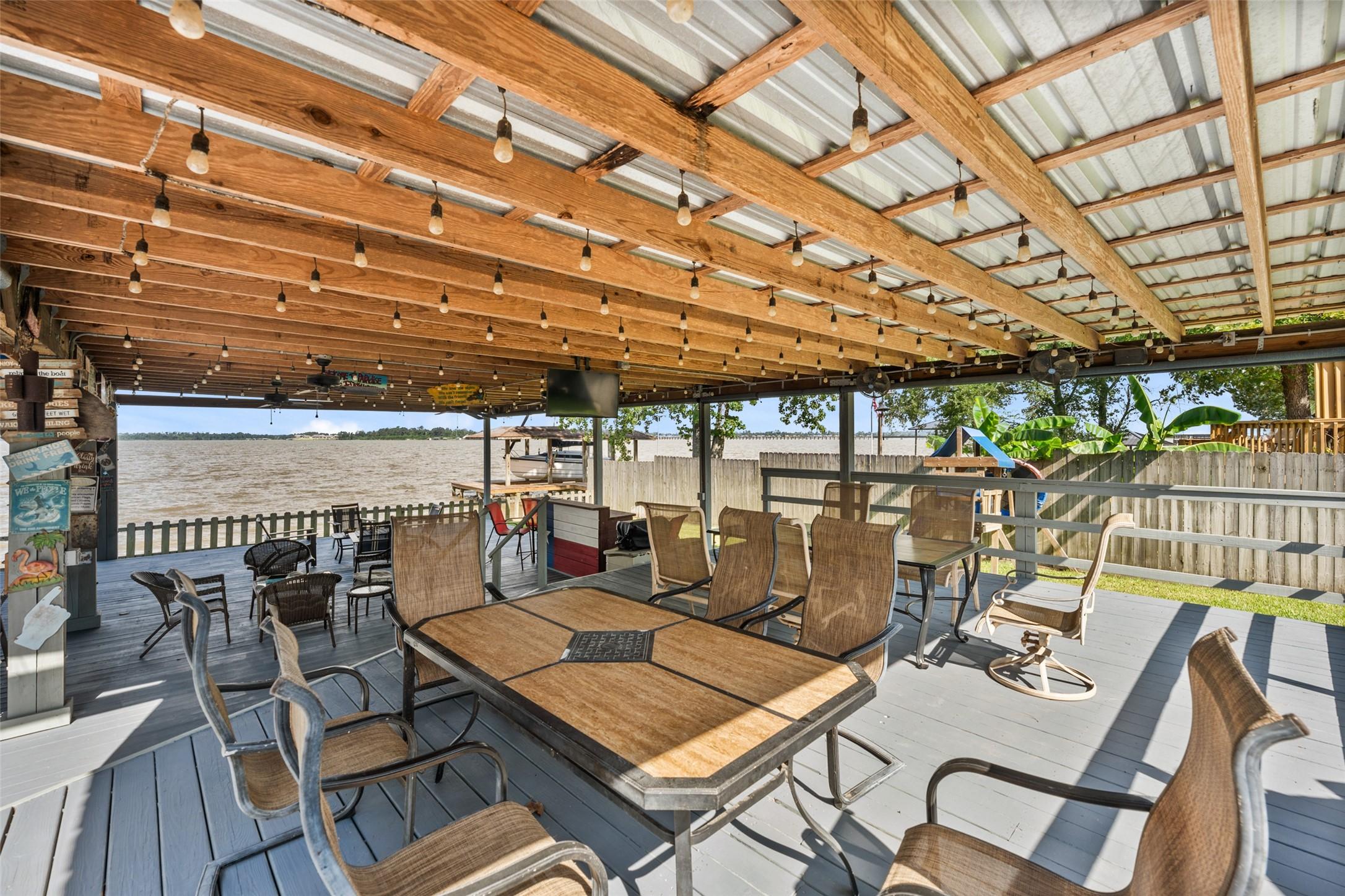 Image 3: Massive covered patio by the water.