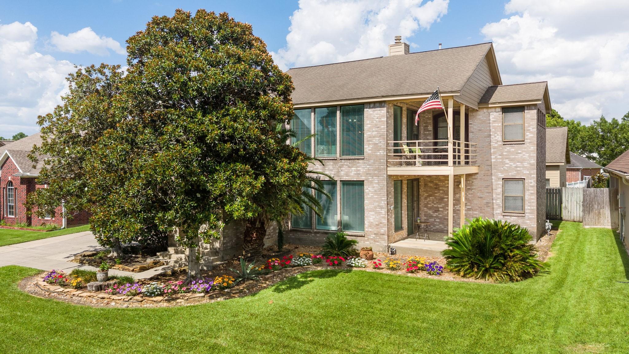 Image 2: Front of Home showing two of the 3 patio areas to