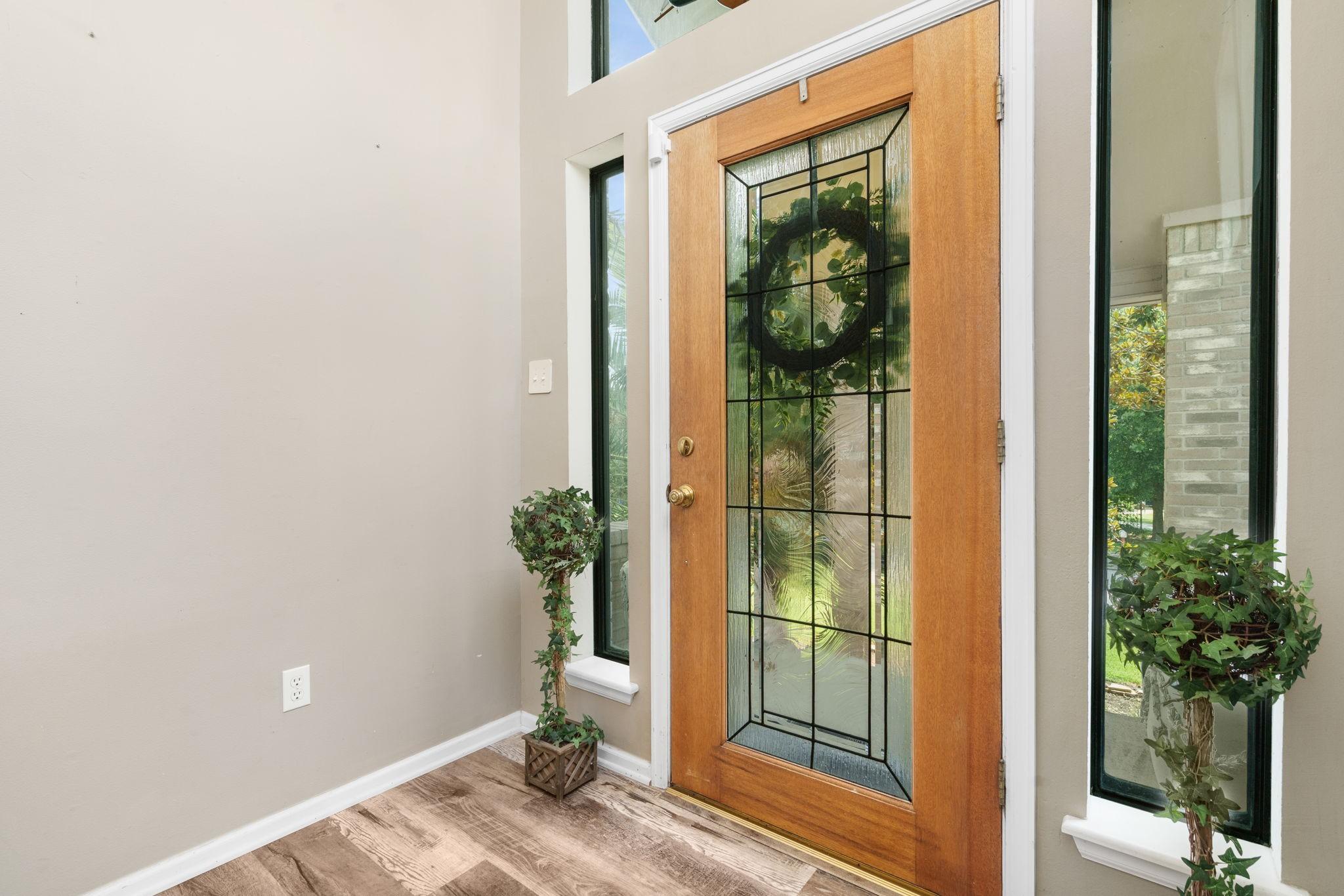 Image 3: Welcoming front entry with beautiful glass front d